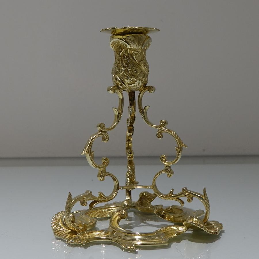 A stunning pair of silver gilt candlesticks designed with open work structure of C-scrolls, some leaf-capped, on a supporting base of open scrolls with rocaille, embellishments. The nozzles are detachable.

 

Weight: 37.62 troy ounces/1170