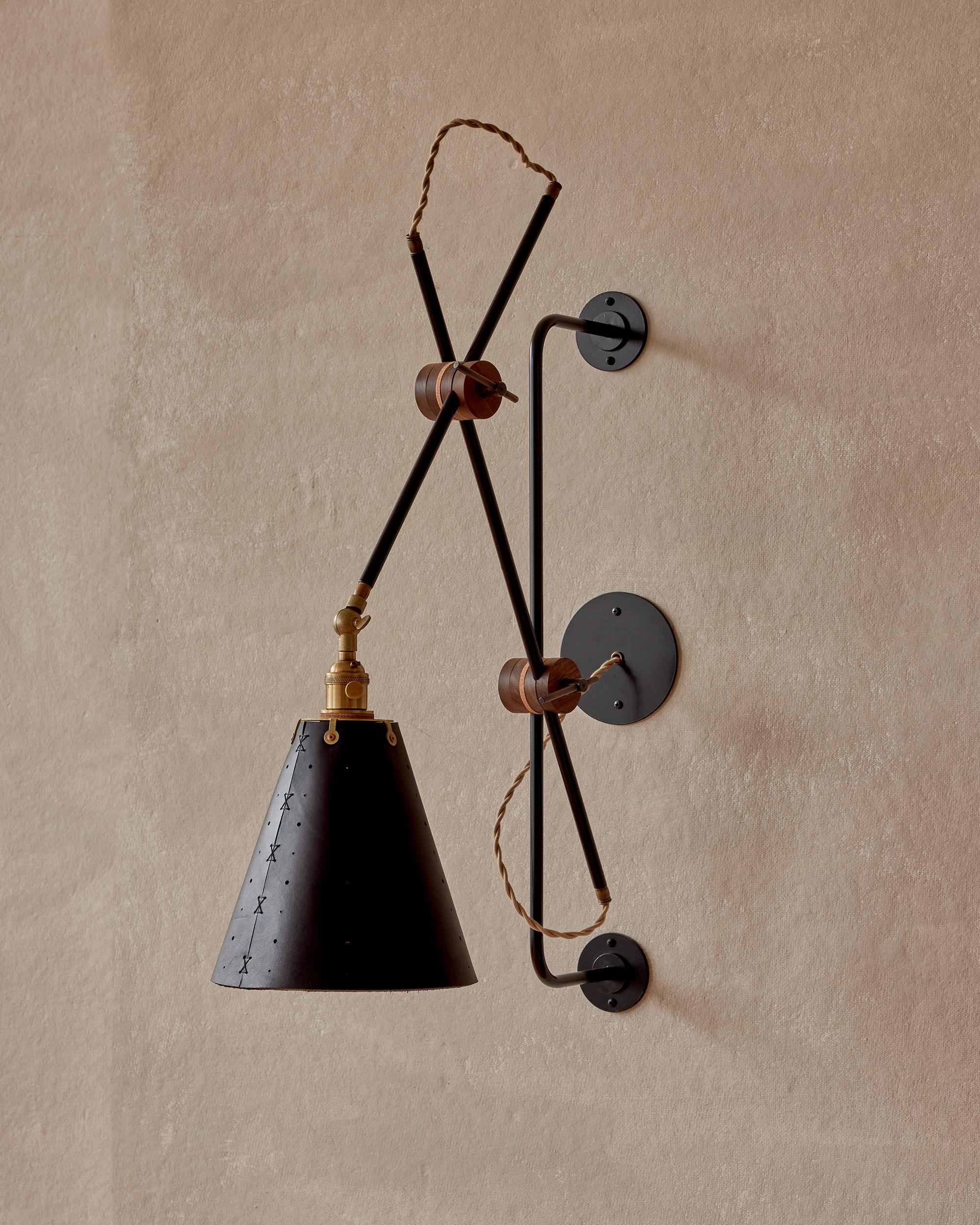 Celebrated for its striking composition and versatility, the Grace Articulating Wall Sconce is a true hallmark of ingenuity in lighting design. As handsome as it is useful, this hardwired sconce connects two lengths of steel piping with a black