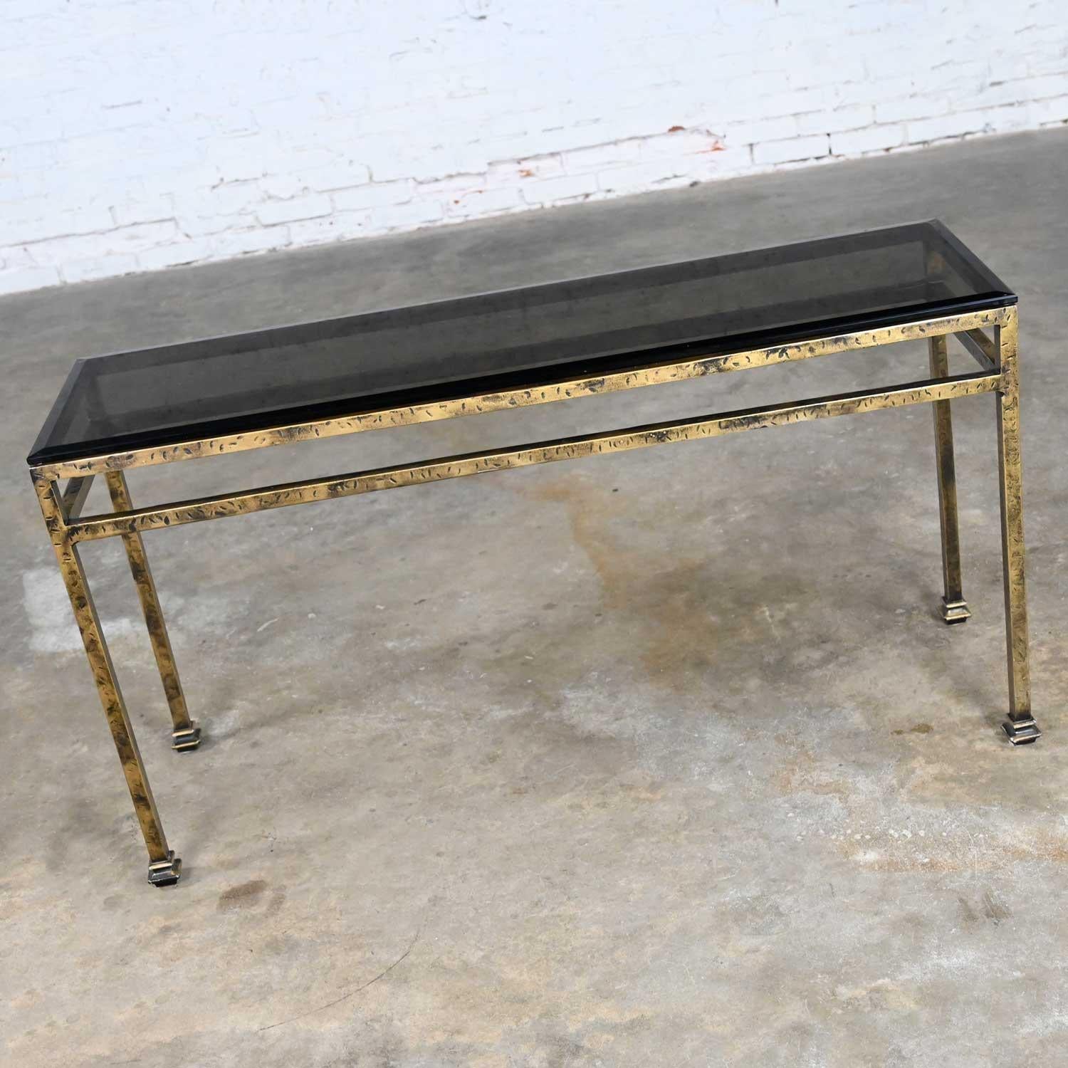 Wonderful modern iron console table with a gold hammered-look and smoked & beveled edge glass top. Beautiful condition, keeping in mind that this is vintage and not new so will have signs of use and wear. Please see photos and zoom in for details.