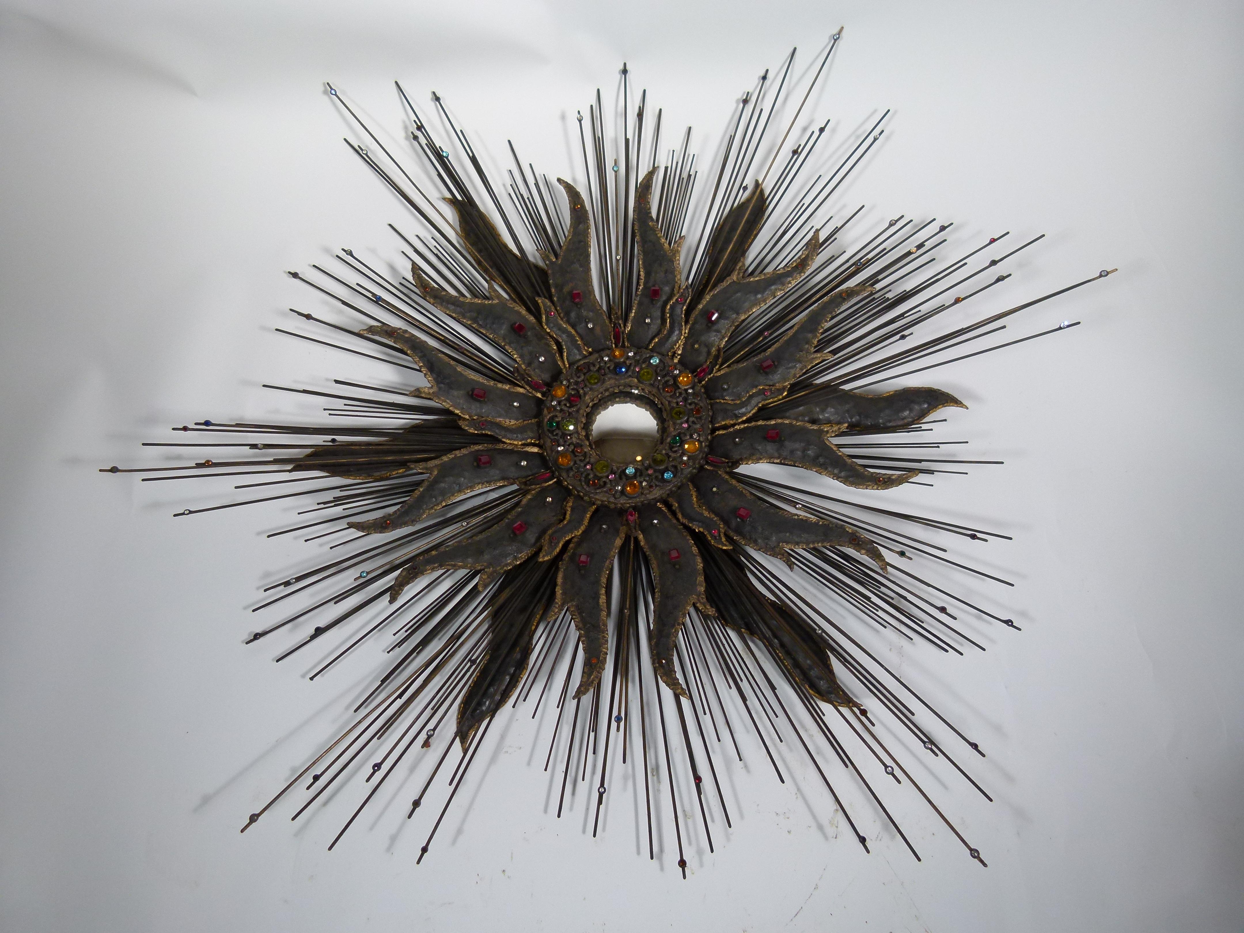 Amazing modern French sunburst mirror. The tiny central mirror is surrounded by a large iron sunburst with small crystals of different colors enlightening and decorating it.

Mirror size: 9cm (3.5 in) diameter.