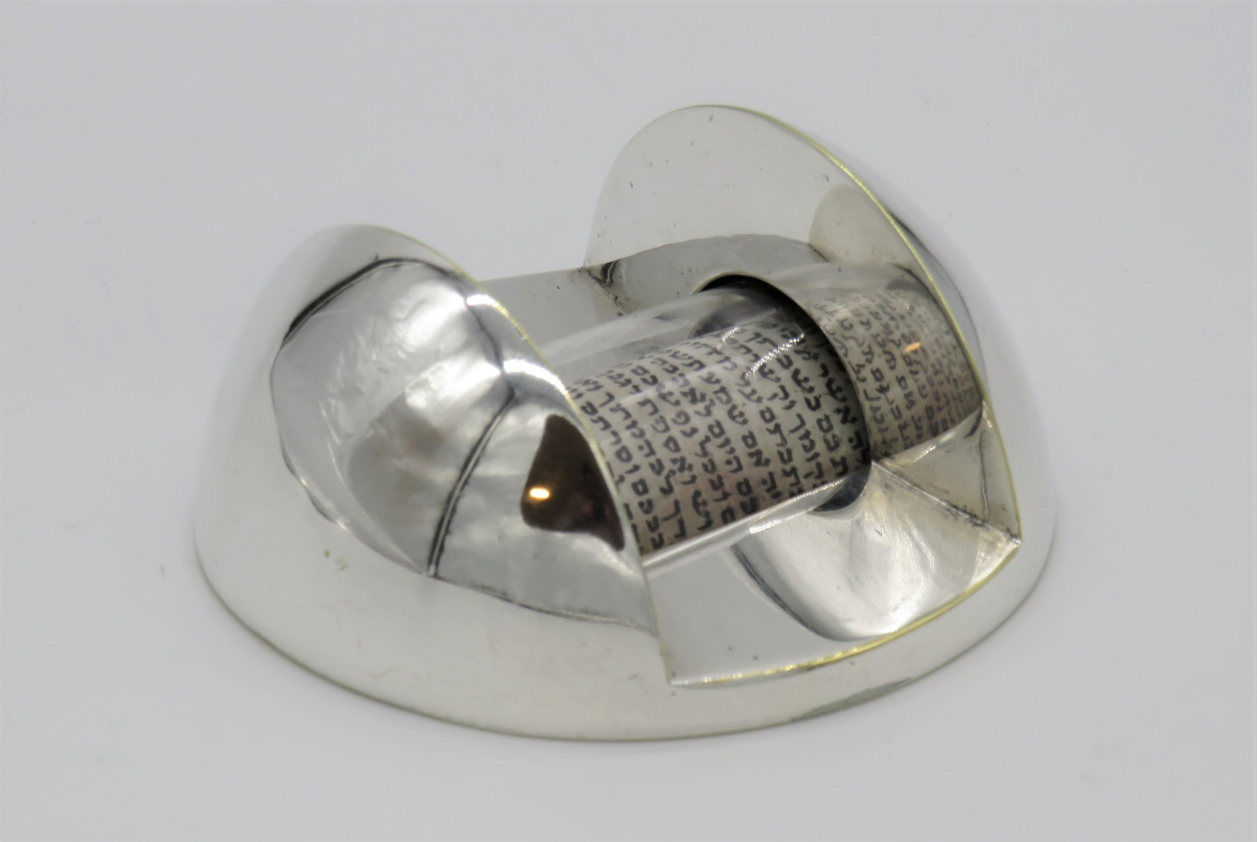 Modern silvered Mezuzah case by Dan Givon, Jerusalem, Israel, 1983.
The Bezalel Academy of Art has awarded the Raphael Prize for Design to this Mezuzah by Dan Givon. This unique shape allows us to actually see and read the beautiful prayer that is