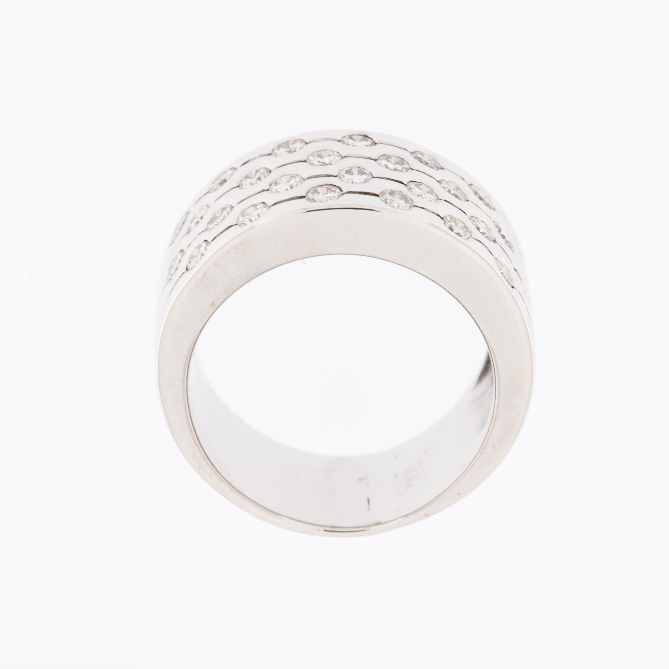 The Modern Italian 18kt White Gold Band Ring with Diamonds is a luxurious and elegant piece of jewelry that reflects contemporary Italian design and craftsmanship. Crafted from 18-karat white gold, the band ring features a sleek and polished surface