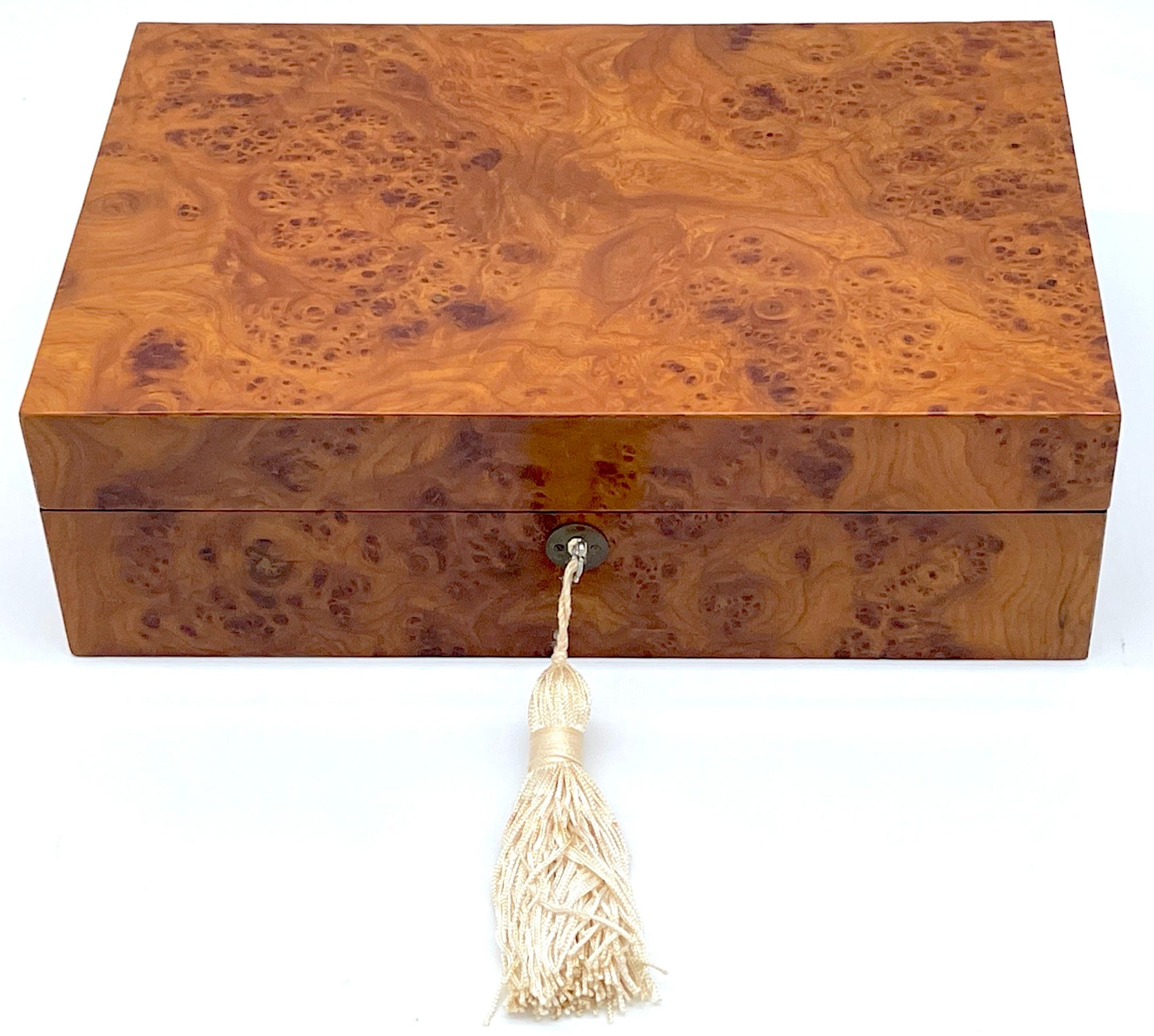 Modern Italian Carpathian Burl Wood Humidor with Tasseled Key
Italy, late 20th century 

A stunning modern Italian Carpathian burl wood humidor is a testament to late 20th-century craftsmanship from Italy. This humidor boasts a rectangular form