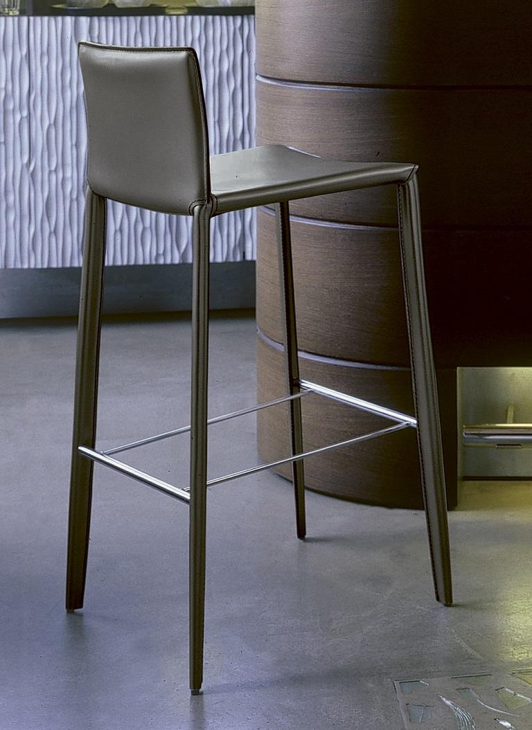 Designed by Daniele Molteni, Linda stool is part of a whole family of chairs and stools. This low Linda stool has a metal frame completely upholstered and covered in Anthracite hide leather with matching stitchings. It is perfect for both elegant