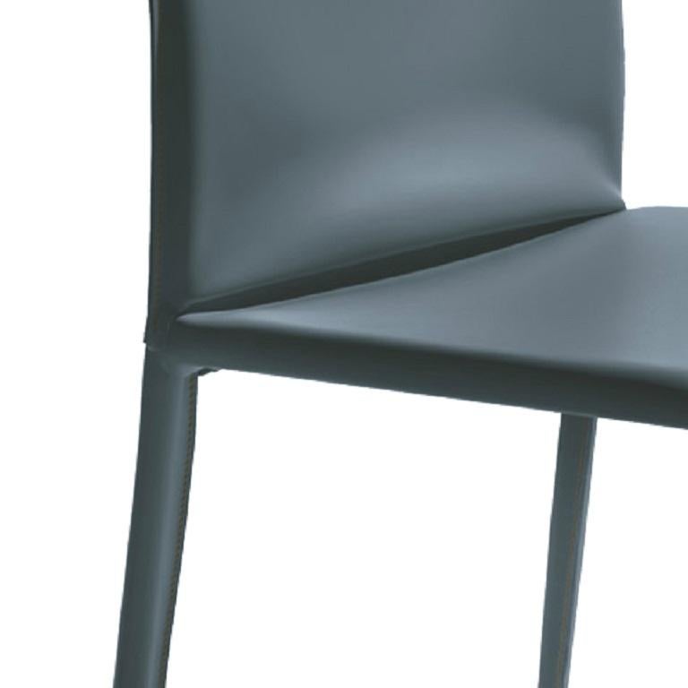 Designed by Daniele Molteni, Linda chair is part of a whole family of chairs and stools. This Linda chair, with high back, has a metal frame completely upholstered and covered in Blue Grey hide leather with Off-white contrast stitchings. It is