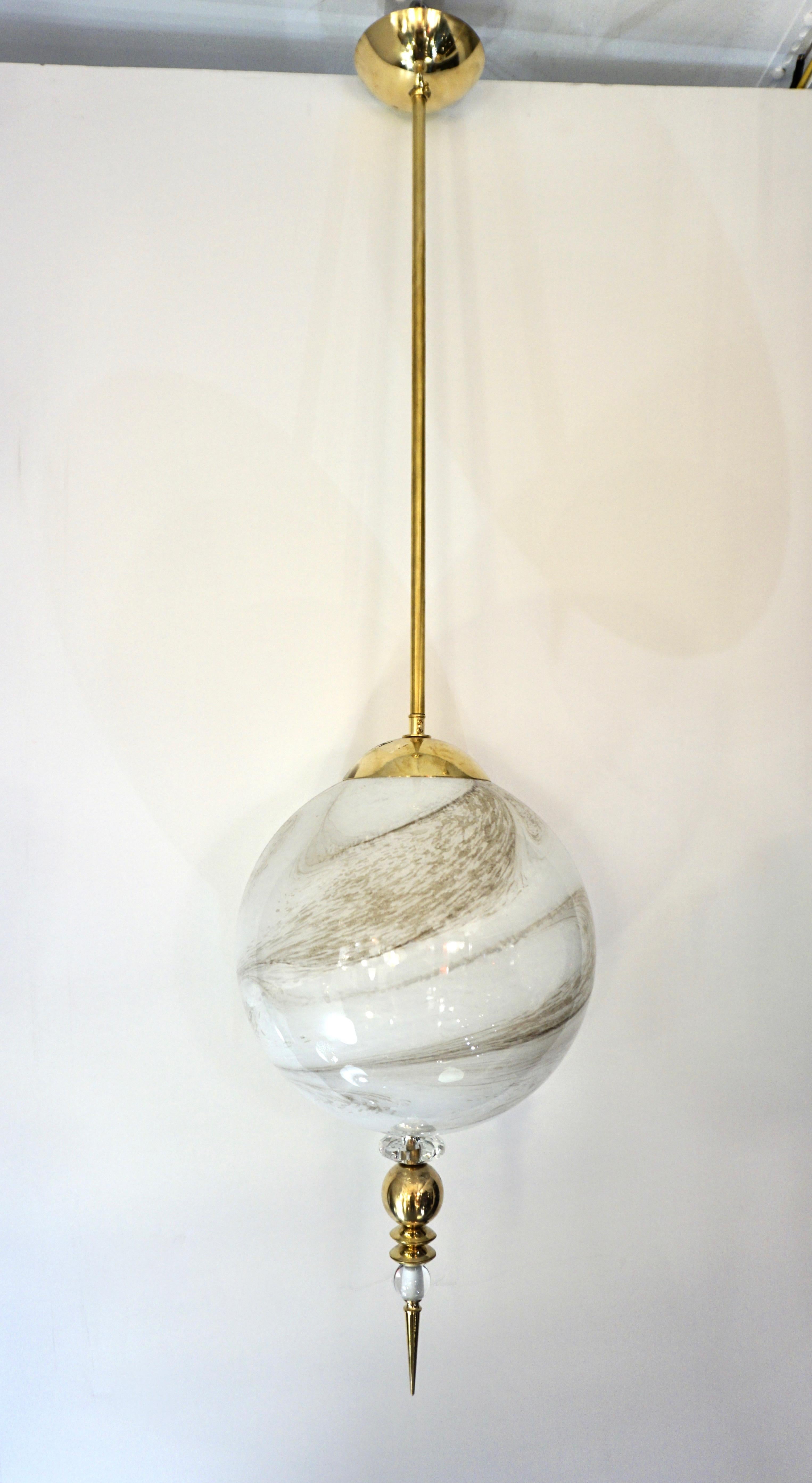 A bespoke set of 3 contemporary pendant chandeliers in a geometric organic series, with globe, oval & cylinder shapes. They are entirely handcrafted in Italy, in an innovative blown Murano glass to resemble alabaster with the benefit of being