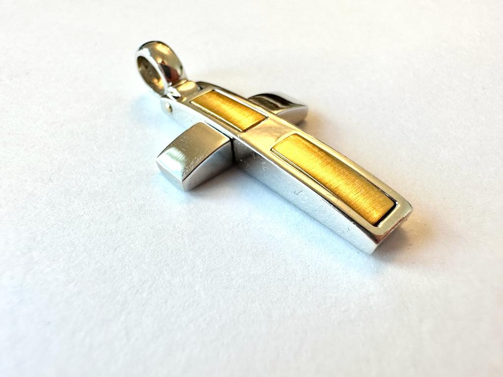 Beautiful modern style Italian cross in 18kt white and yellow gold. The white gold part is polished while the yellow gold part has been worked on with the 