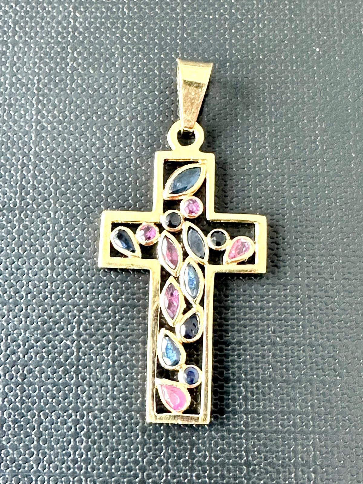 This delicate Cross has a beautiful and modern design due to the different colored Quartz: pink, blue and midnight blue. The stones have different cuts: brilliant, pear and marquise. Each stone has its own setting to better highlight its color. The