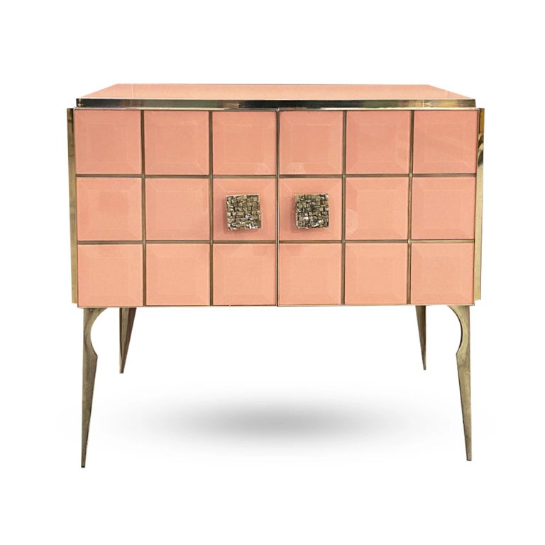 Bring glamour to your room with this bespoke customizable modern cabinet, entirely handcrafted in Italy, with a Hollywood Regency feel. The surround is decorated with art glass in a striking brilliant salmon rose color, striped vertically and