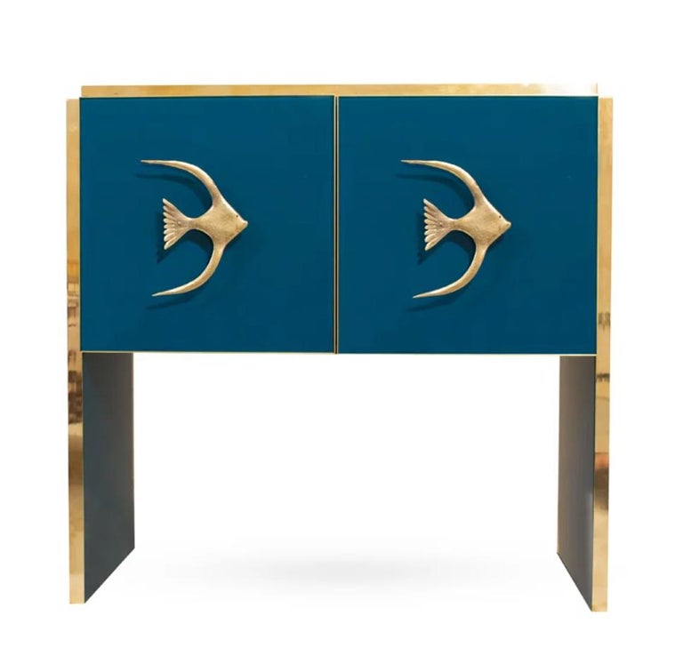Bring the ocean in your space with this contemporary bespoke customizable 2-door console / small sideboard, entirely handcrafted in Italy, with a minimalist Art Deco feeling, the surround decorated with art glass in an enticing light cobalt teal