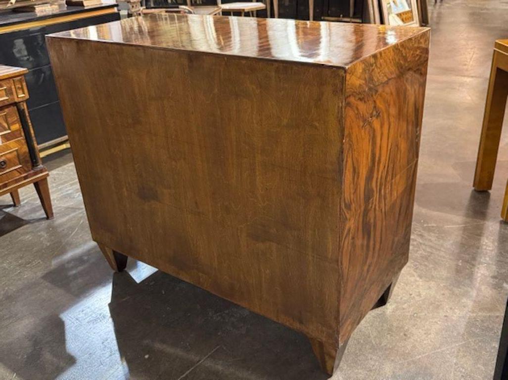 This product is a modern Italian exotic veneer commode, a stylish piece of furniture for the home. With a sleek design and luxurious veneer finish, this commode exudes a trendy and sophisticated aesthetic. The exotic veneer adds a touch of elegance