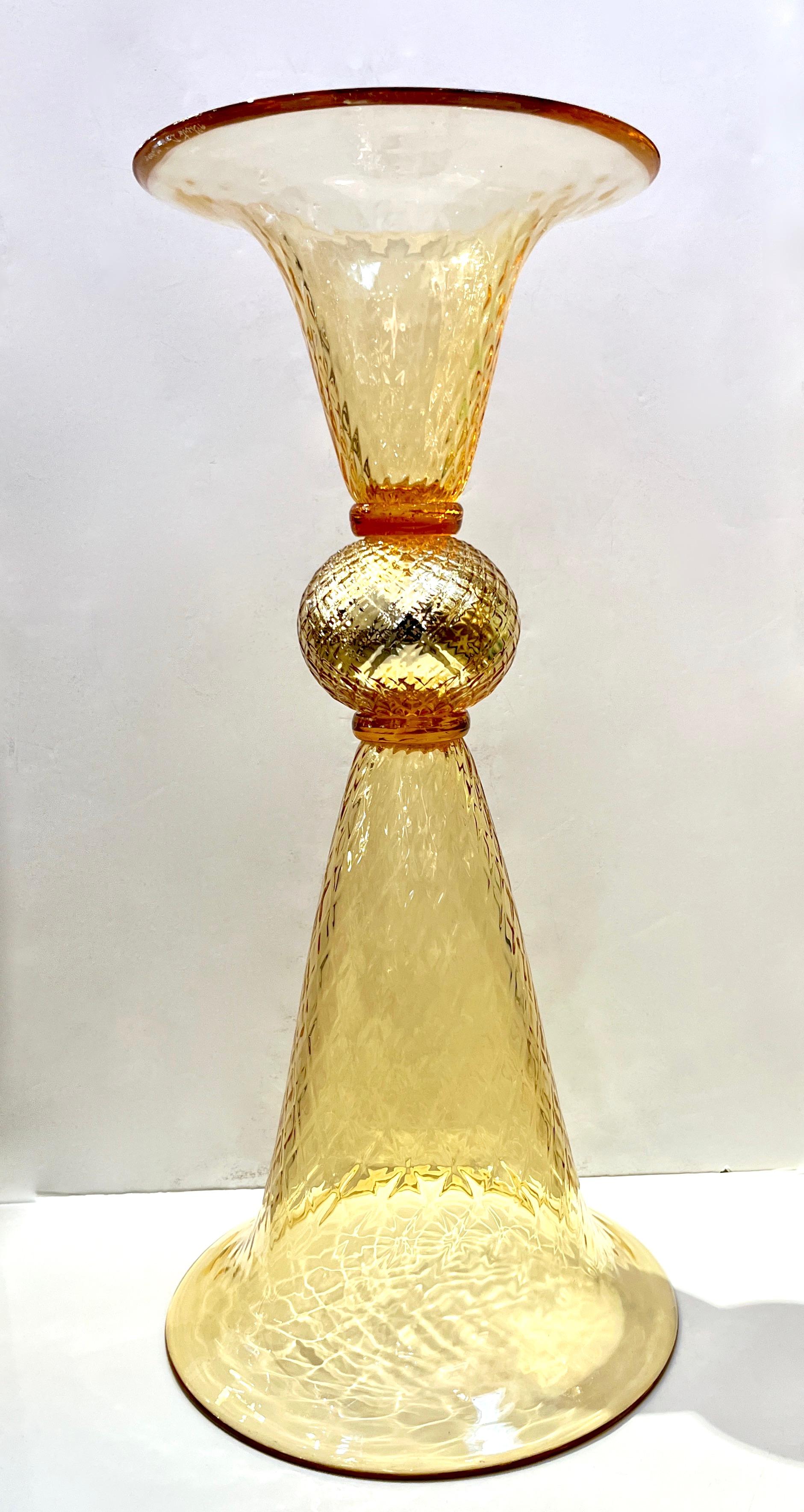 Contemporary Venetian Decorative Arts gold vase, in blown Murano glass, worked with pure 24k gold, one part more elongated than the other and both can function as a base. The bodies are both in textured glass with a honeycomb pattern that multiplies