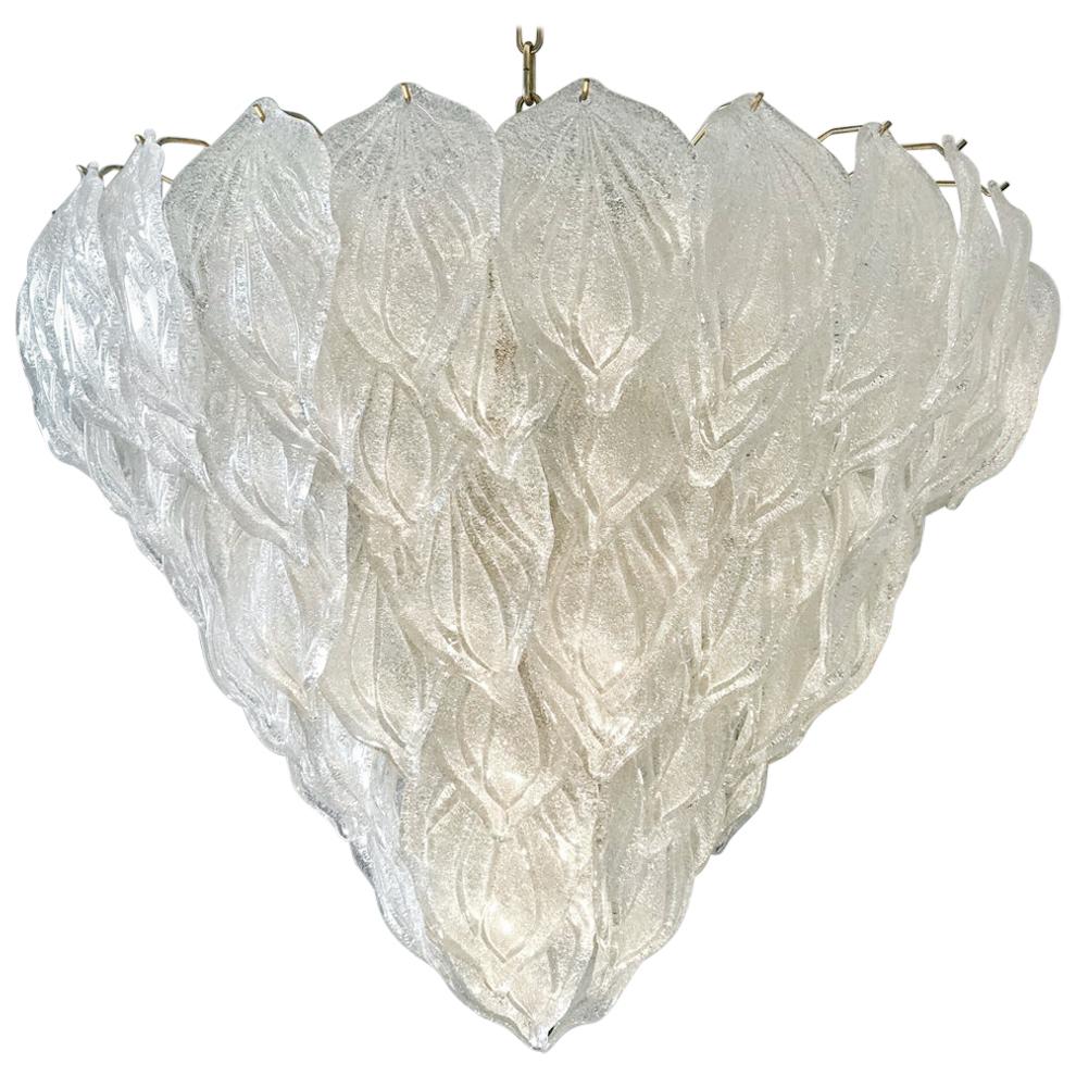 Murano Polar ice chandelier, each with 88 precious hand blown glass leaves hanging on the brass frame. Spectacular light effect.
Available also a pair and four pair of sconces.
Provenance from a luxury hotel.
Measures: Height 75 cm, with chain