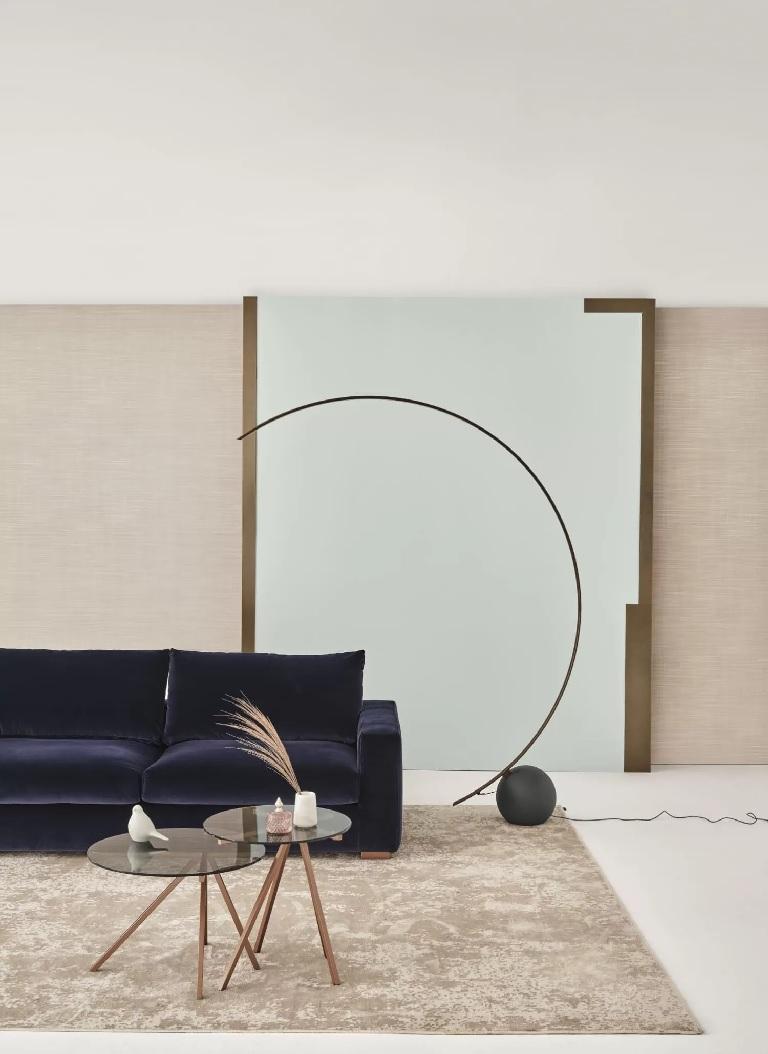Designed by Studio Design F+B, this floor lamp is made of a metal frame in dark brass and a concrete base, it is a metal arch melded into a concrete ball, a piece of art that combines the unique style of floor lamp with the shape of a precious