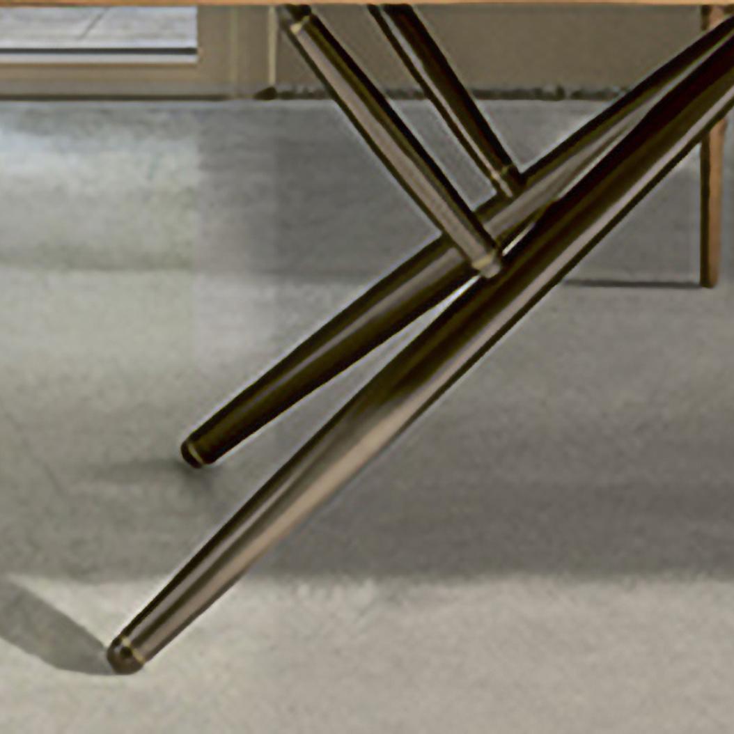 The timeless and iconic trestle base is the distinctive feature of Bridge table. Elegant, studied in detail, Bridge table is a fixed rectangular table great to be used as a dining table or as an executive desk. Its frame is in Dark Brass lacquered