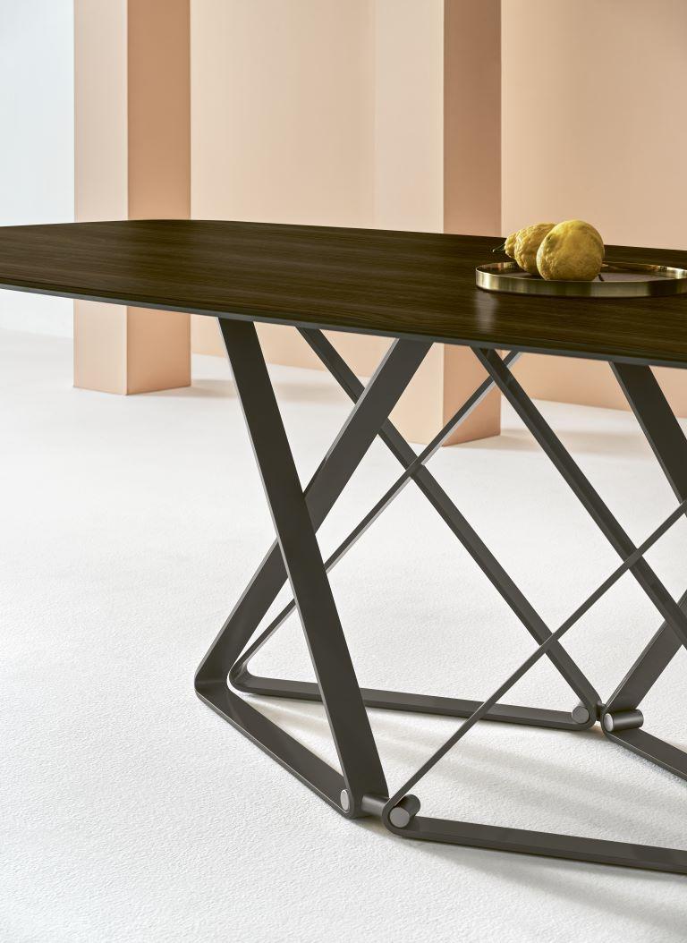 Designed by Bernhardt & Vella, its geometric shapes intersected by precious details give to Delta table a strong and refined character in any environment. This is a Fixed table with barrel shaped top. The frame is in anthracite lacquered metal,