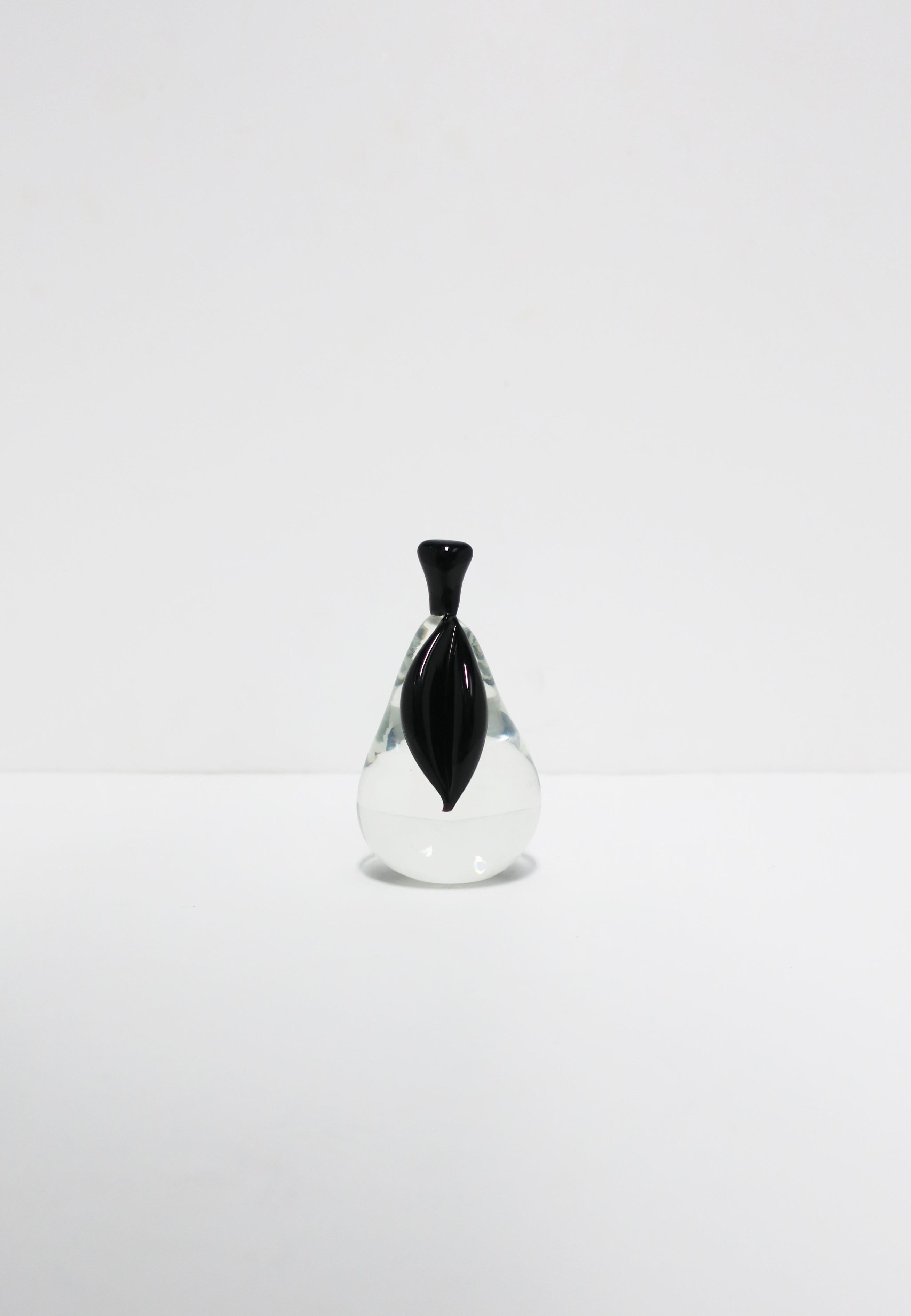 A beautiful Italian Murano art glass pear fruit sculpture by Archimede Seguso, Murano, Italy, circa mid-20th century. This beautifully designed and handcrafted pear fruit sculpture in clear transparent with a black leaf and stem. Piece is marked
