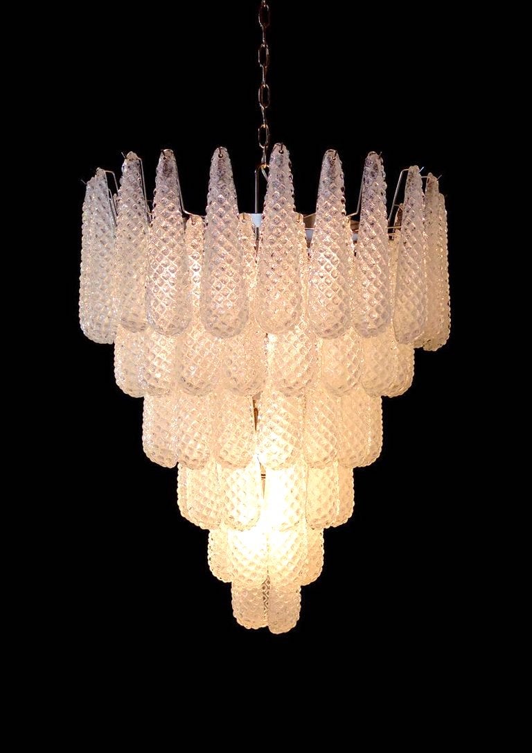 Fine Italian Murano chandelier made by 52 glass petals (transparent crystal, smooth outside, with
crystal powder and then rough inside.) with a chrome frame.
Period: 1970s-1980s.
Dimensions: inches (75 cm) height without chain; 26 inches (66