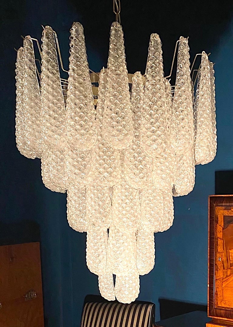 Fine Italian Murano chandelier made by 52 glass petals (transparent crystal, smooth outside, with
crystal powder and then rough inside.) with a chrome frame.
Period: 1970s-1980s.
Dimensions: inches (75 cm) height without chain; 26 inches (66