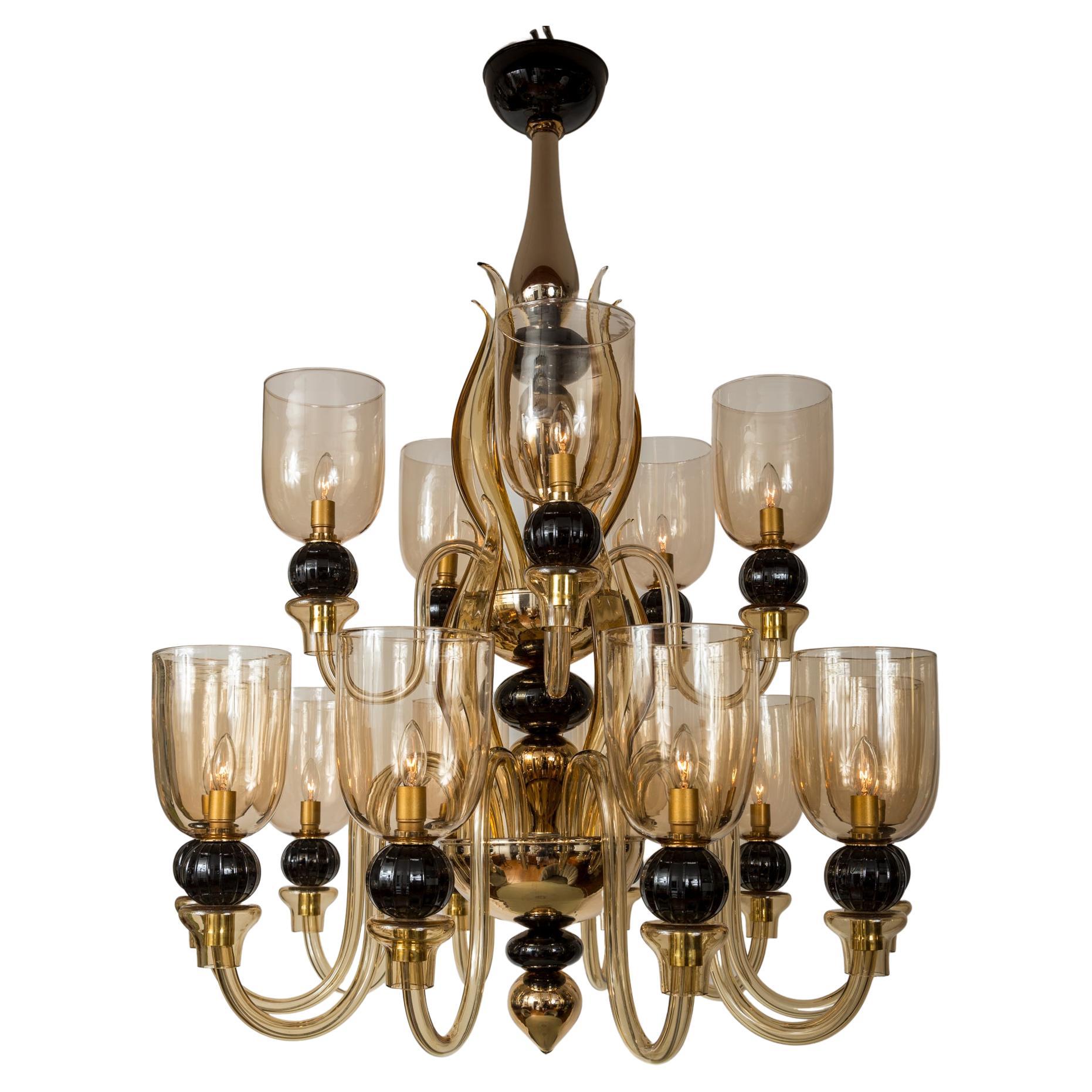 Exemplary masterful work by Maestro Seguso, re-blown from their 1940' s model showcasing a robust and still modern style two-tiered mercury silver, black and amber colored glass chandelier. Its center shaft surrounded by twelve sleek amber leaves
