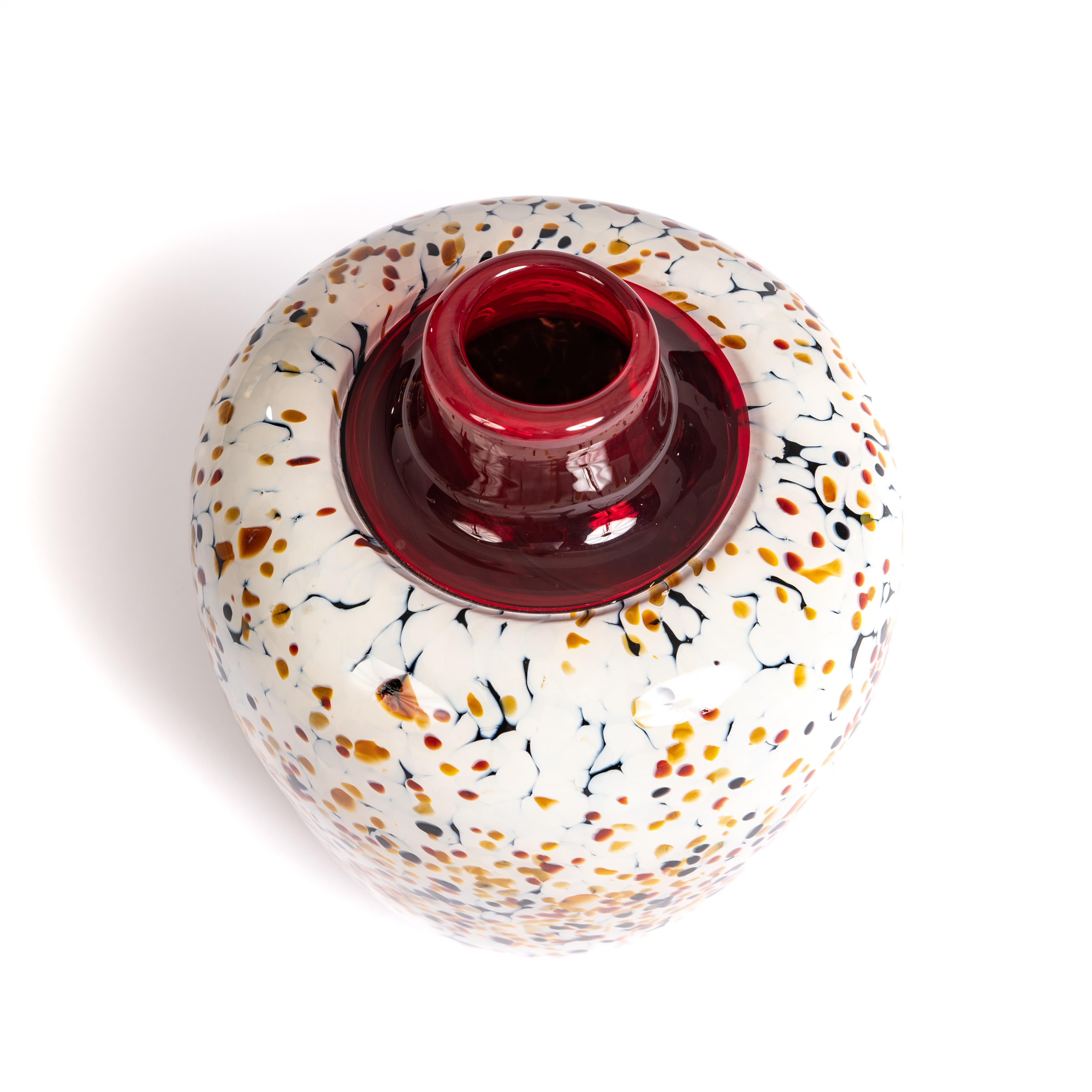Modern Italian Murrine Murano glass vase in red-off white-black-camel by Paolo Crepax
Conical vase shape with plain red transparent vase opening. The body glass is not transparent but appears dense.
The white is more of a creamy white the colored