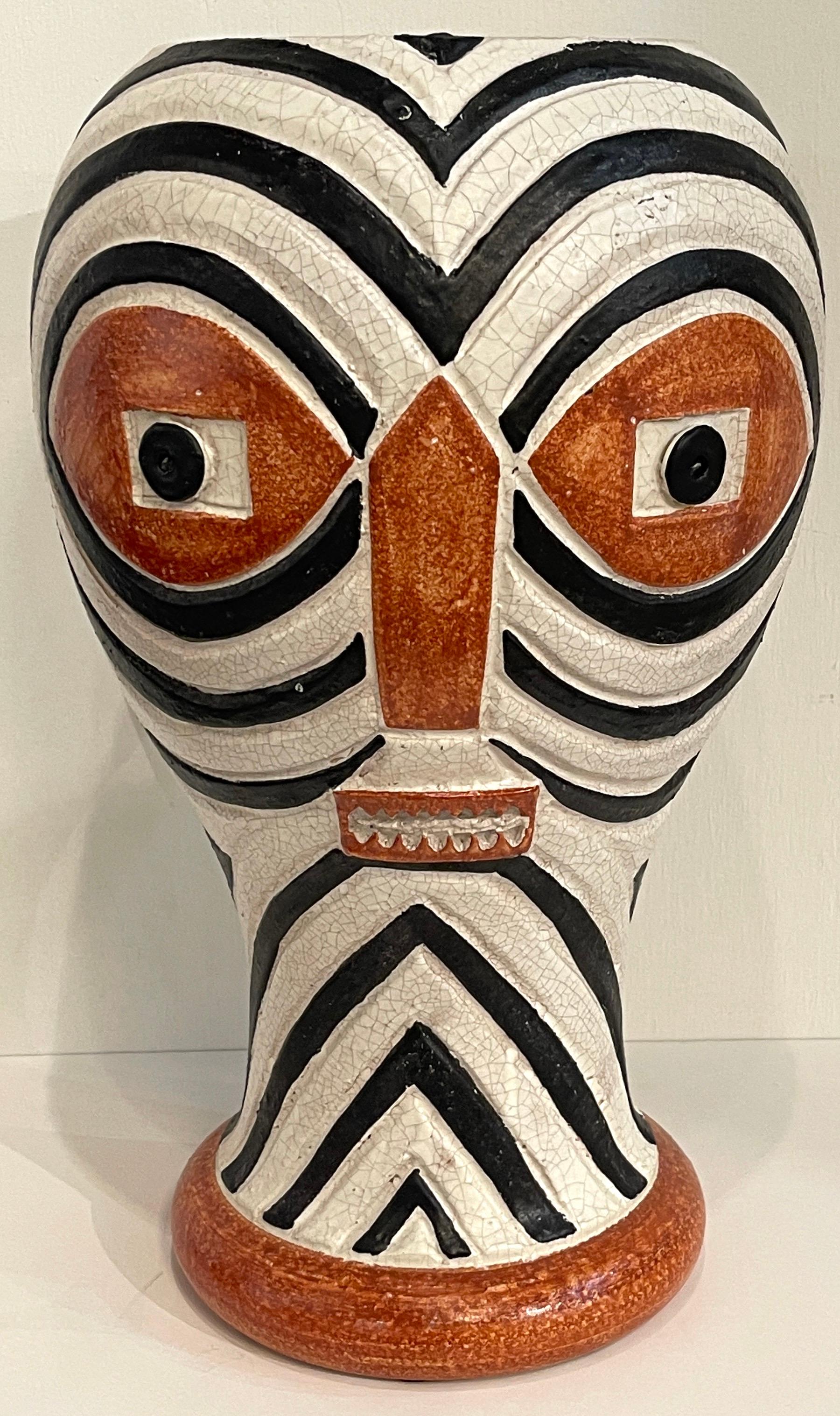 Modern Italian Pottery Mask Motif vase, by ND Dolfi, retailed by Neiman Marcus, C. 1990s
Large well sculpted and painted geometric 'mask' vase, with all over decoration. 
Standing 19