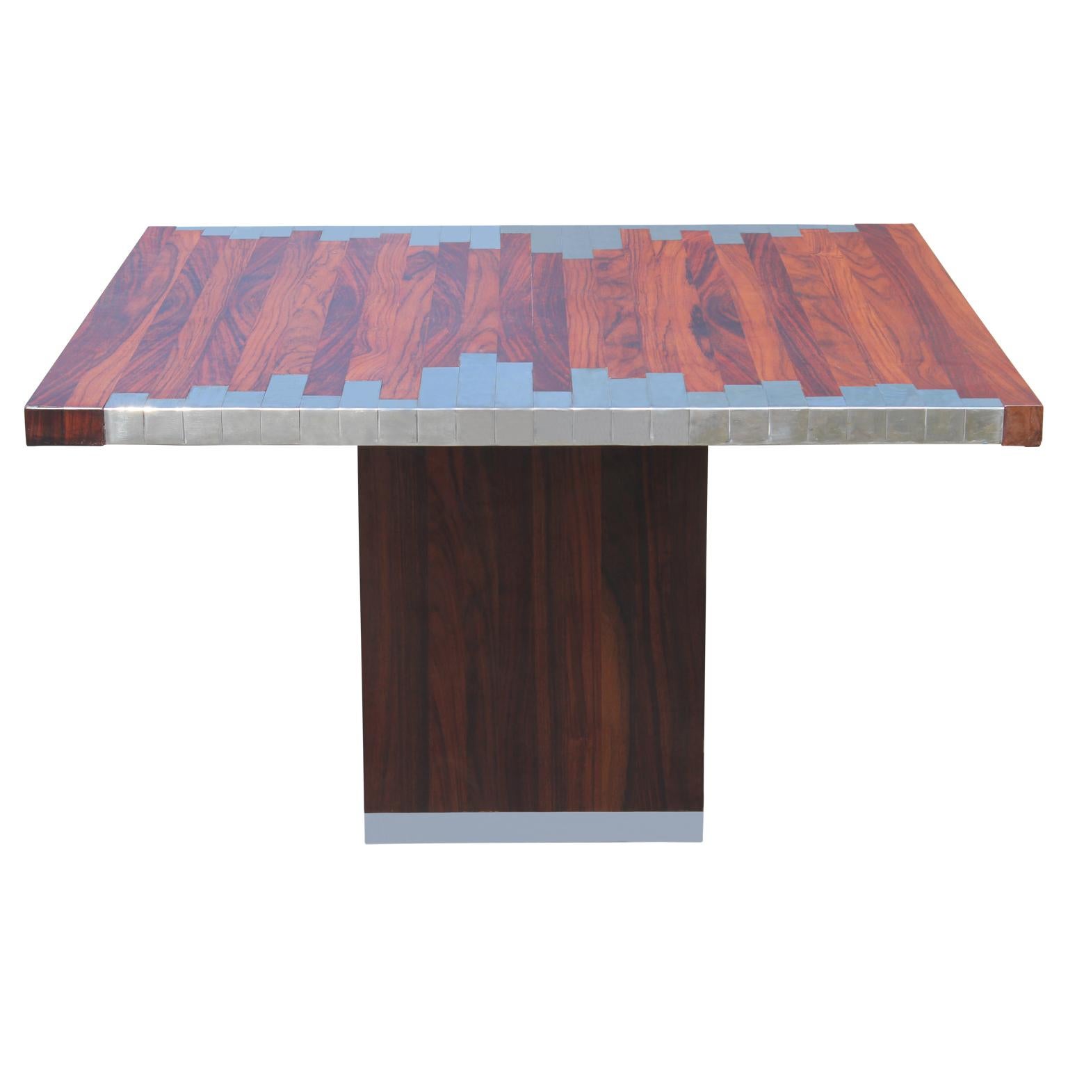 Gorgeous modern square Italian rosewood pedestal dining table with a unique geometric inlay and chrome detailing at the base. Perfect statement piece for entertaining.