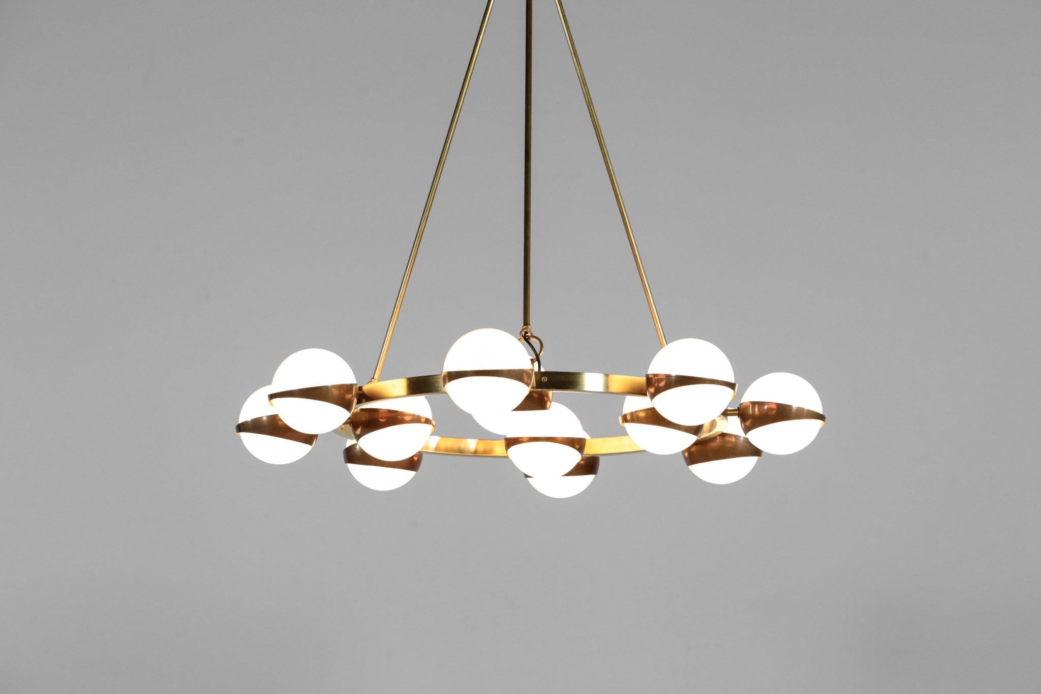 Amazing design chandelier in the style of Stilnovo. Composed of brass structure with 12 opaline glass. Customizable on request. We also have the same one with 20 opaline glass) Customers can choose finish brass (dark, polish or brilliant).