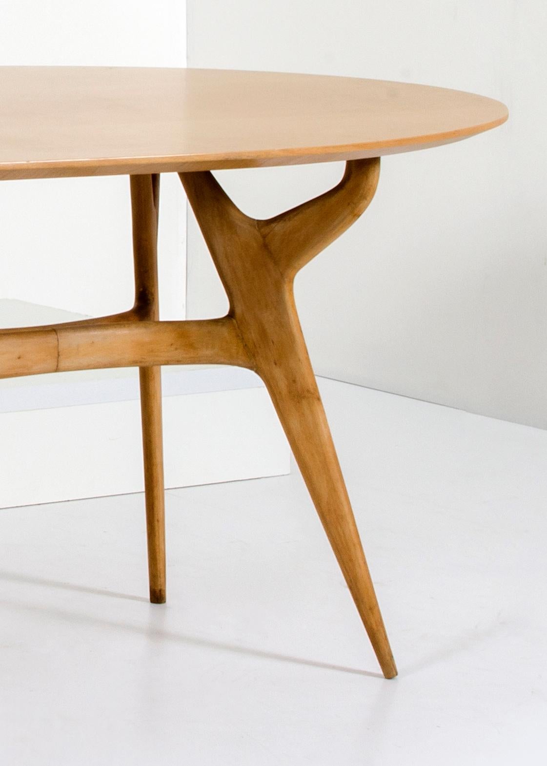 A solid maplewood dining table from 1950s. It comfortably seats six people but is suitable for up to eight diners. The top is removable and is fixed with metal brackets at each leg. There is some scratching to the underside of the top , however the