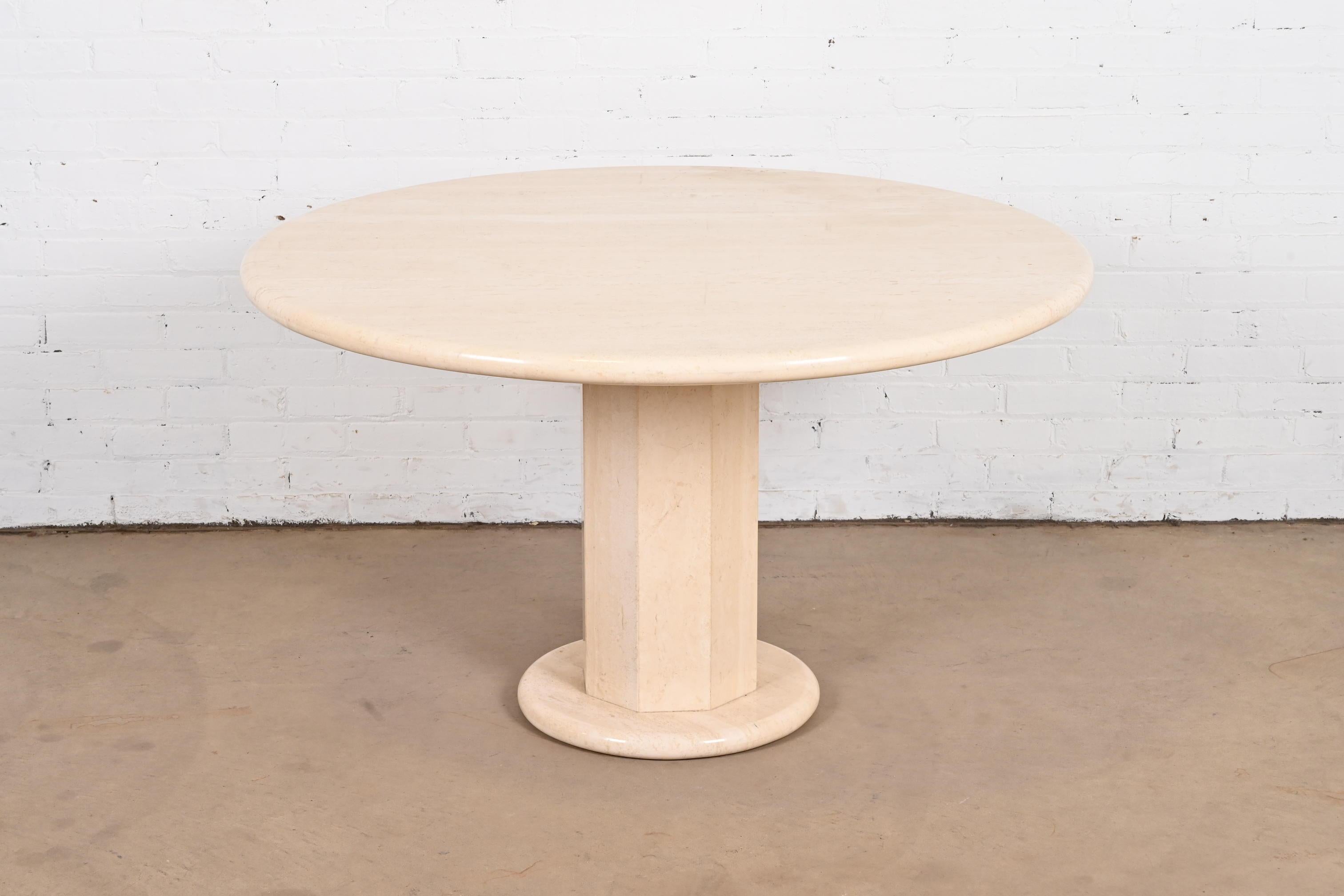 An exceptional modern Italian travertine round pedestal dining table, game table, or center table

By Ello

Italy, circa 1970s

Measures: 48