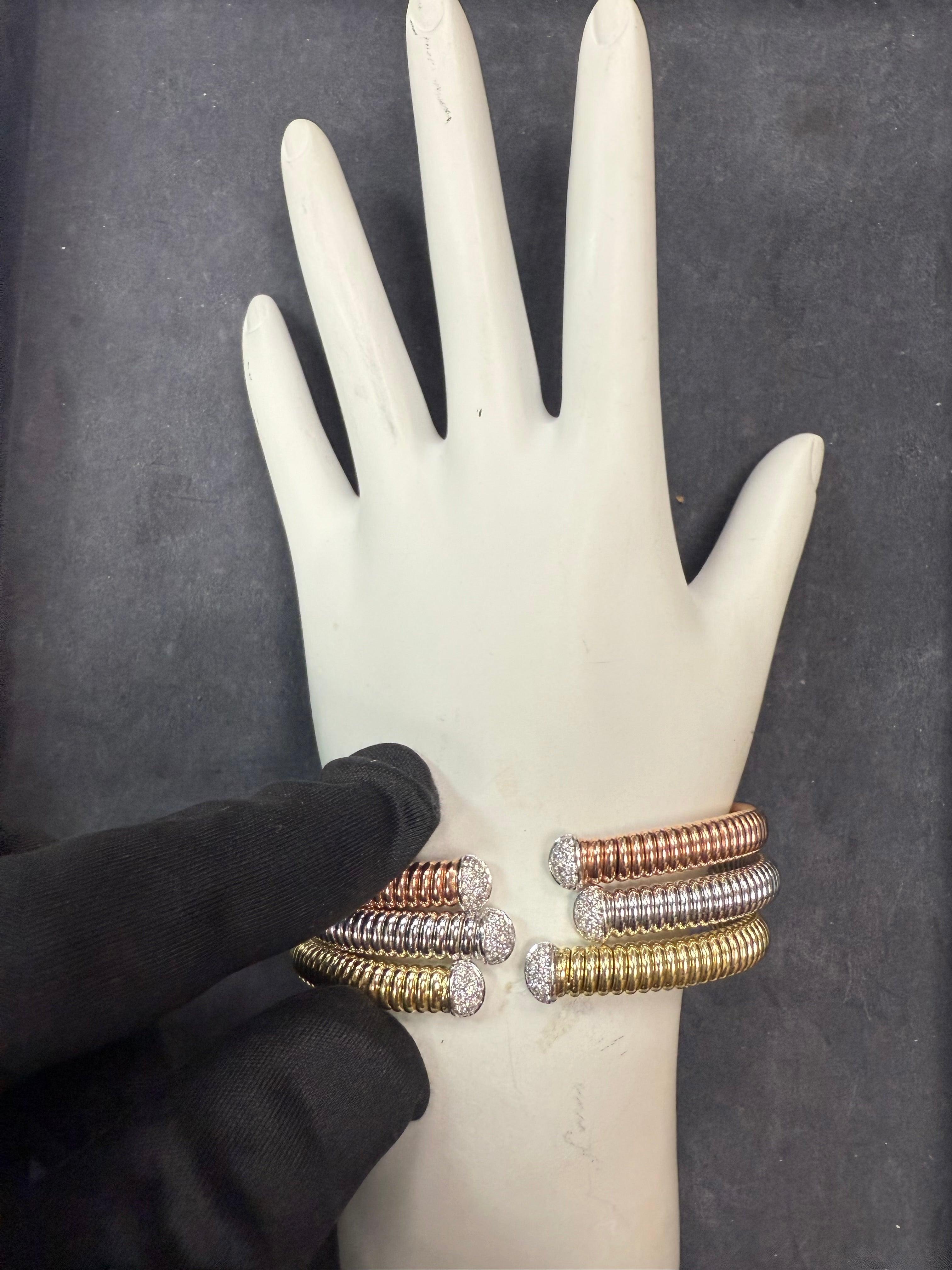 Modernes italienisches, dreifarbiges, flexibles Armreif-Set des Designers HERCO, gefertigt aus 18 K Gelbgold, 18 K Weißgold und 18 K Roségold. Jeder der drei Armreifen ist gepunzt und misst etwa 6,5 Zoll im Innenumfang mit einer flexiblen Öffnung