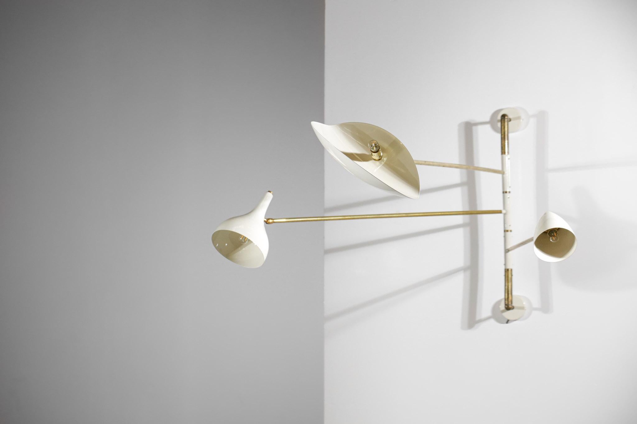 Very original modern wall lamp with three arms. Handcrafted in Italy.  Structure and arms in solid brass, lampshade and wall cups in white lacquered metal. Possibility to orientate the three arms and the lampshades in different positions. Excellent