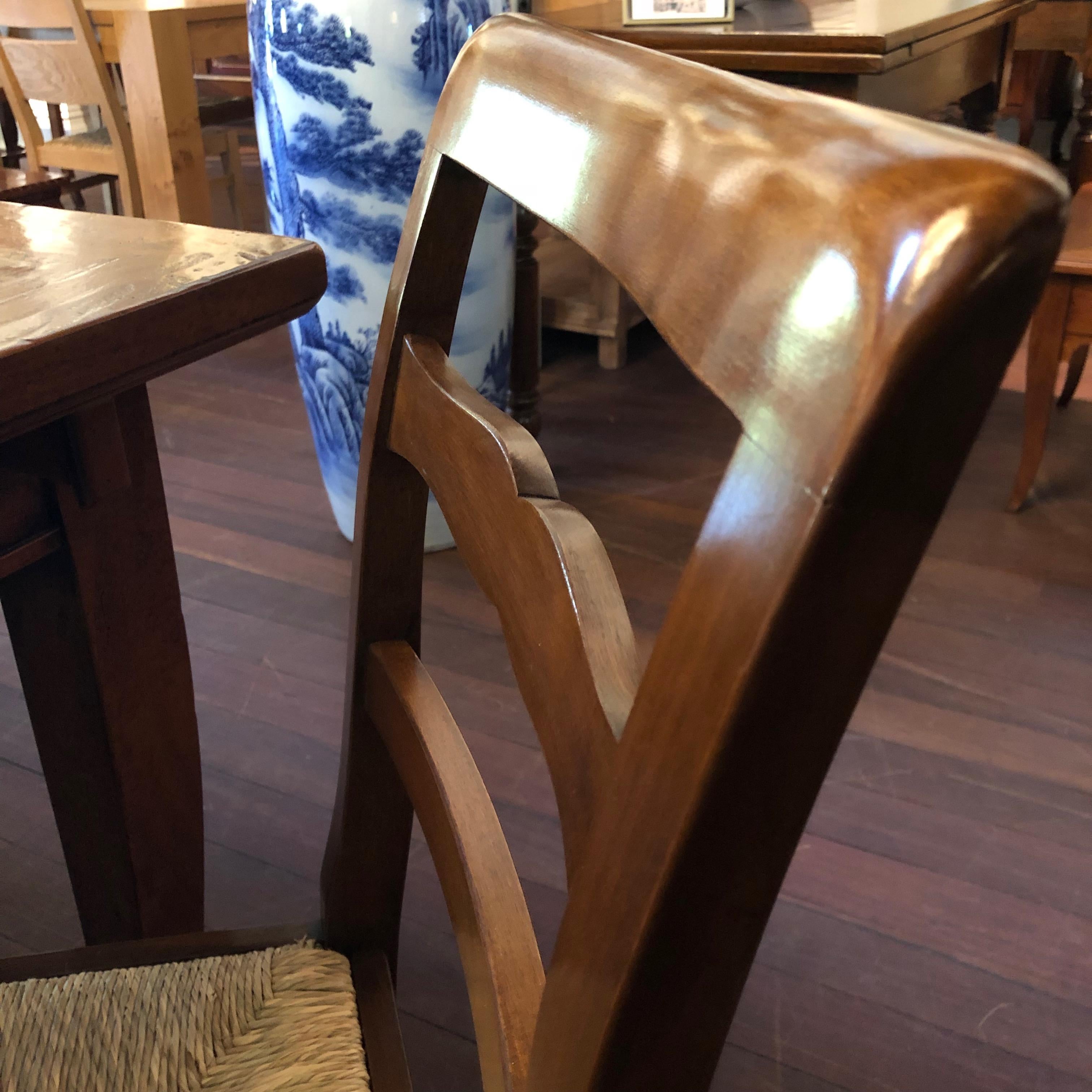 There are 10 of these rustic Italian walnut ladder back dining chairs currently available. They feature beautiful rush seating with hand carved, delicately rounded ladder backs and slightly curved legs. These chairs have been handcrafted in Italy
