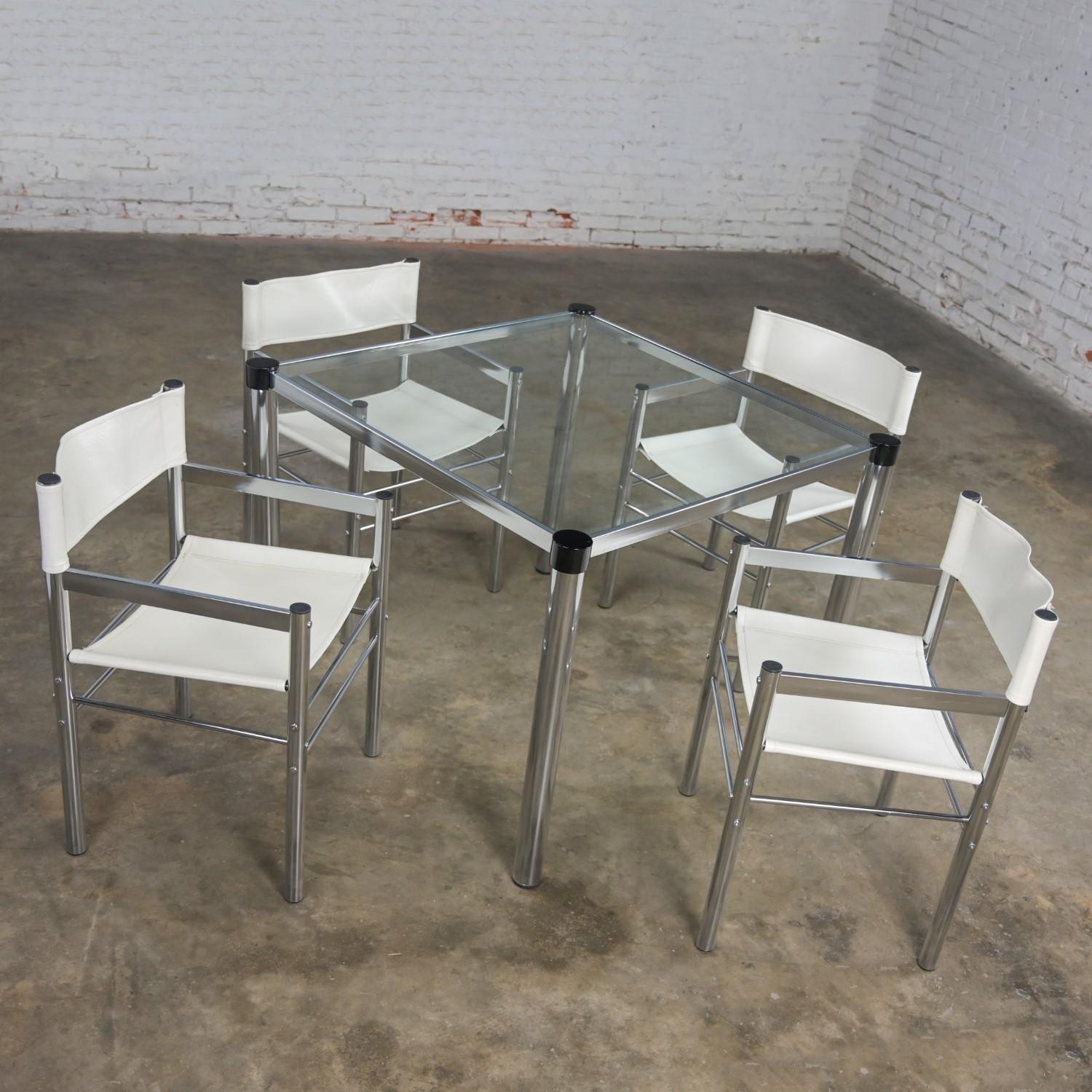 Wonderful vintage Modern James David style chrome & glass square dinette set or game table with 4 chrome tube & white vinyl directors sling chairs. Beautiful condition, keeping in mind that these are vintage and not new so will have signs of use and