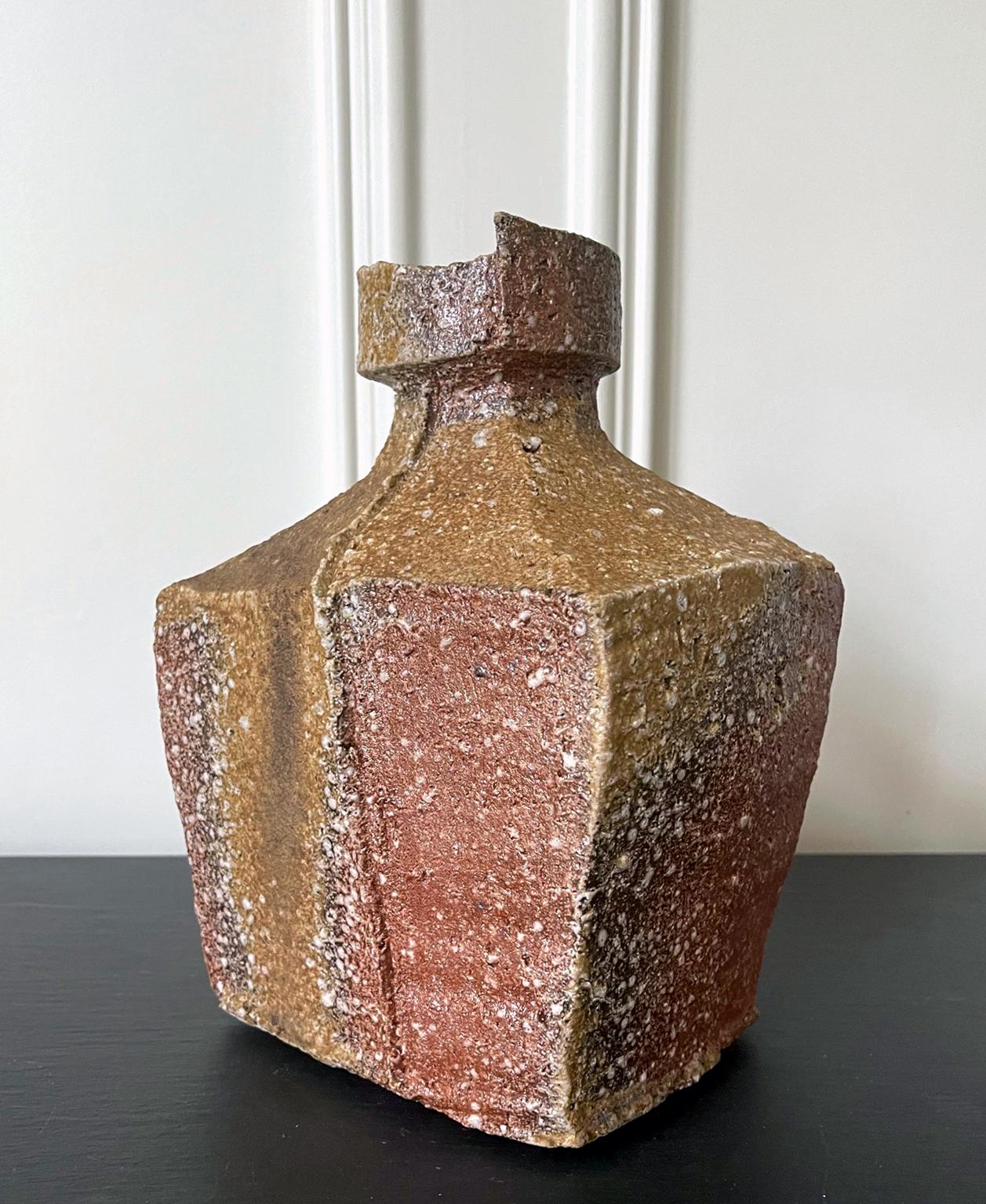 A modern ikebana vase in a rectangular form made in the tradition of Shigaraki ware by celebrated Japanese potter Kohyama Yasuhisa (1936-). Born in the town of Shigaraki, Yasuhisa was one of the first potters who revived the ancient techniques by