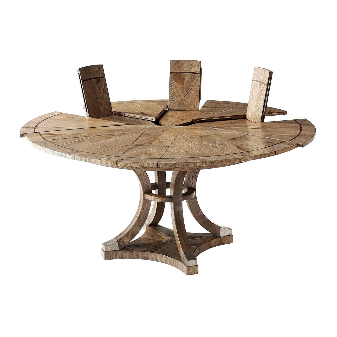 Modern oak parquetry and walnut inlaid top round self-storing extension dining table with six pull out top sections opening to reveal 6 fold-out leaves, above inswept solid oak legs with a central collar and 'Vintage' metal cast cappings.

Open