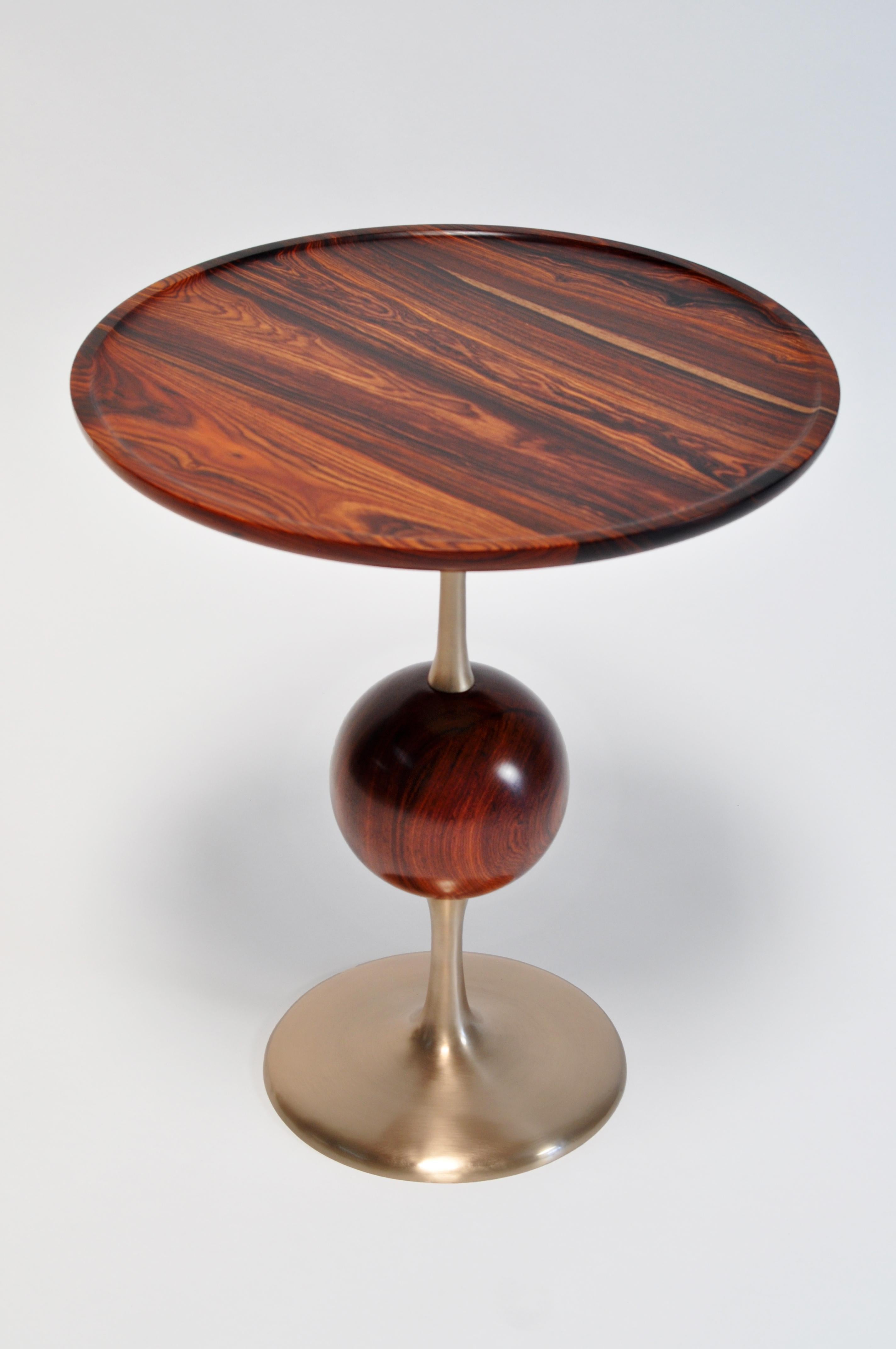 Our Jupiter series mixes art cast bronze bases with hand turned wood orbs and tops. Each base is cast by a foundry that specializes in sculptural bronze work and is hand chased and polished. Our woods are selected from the finest sources for grain,