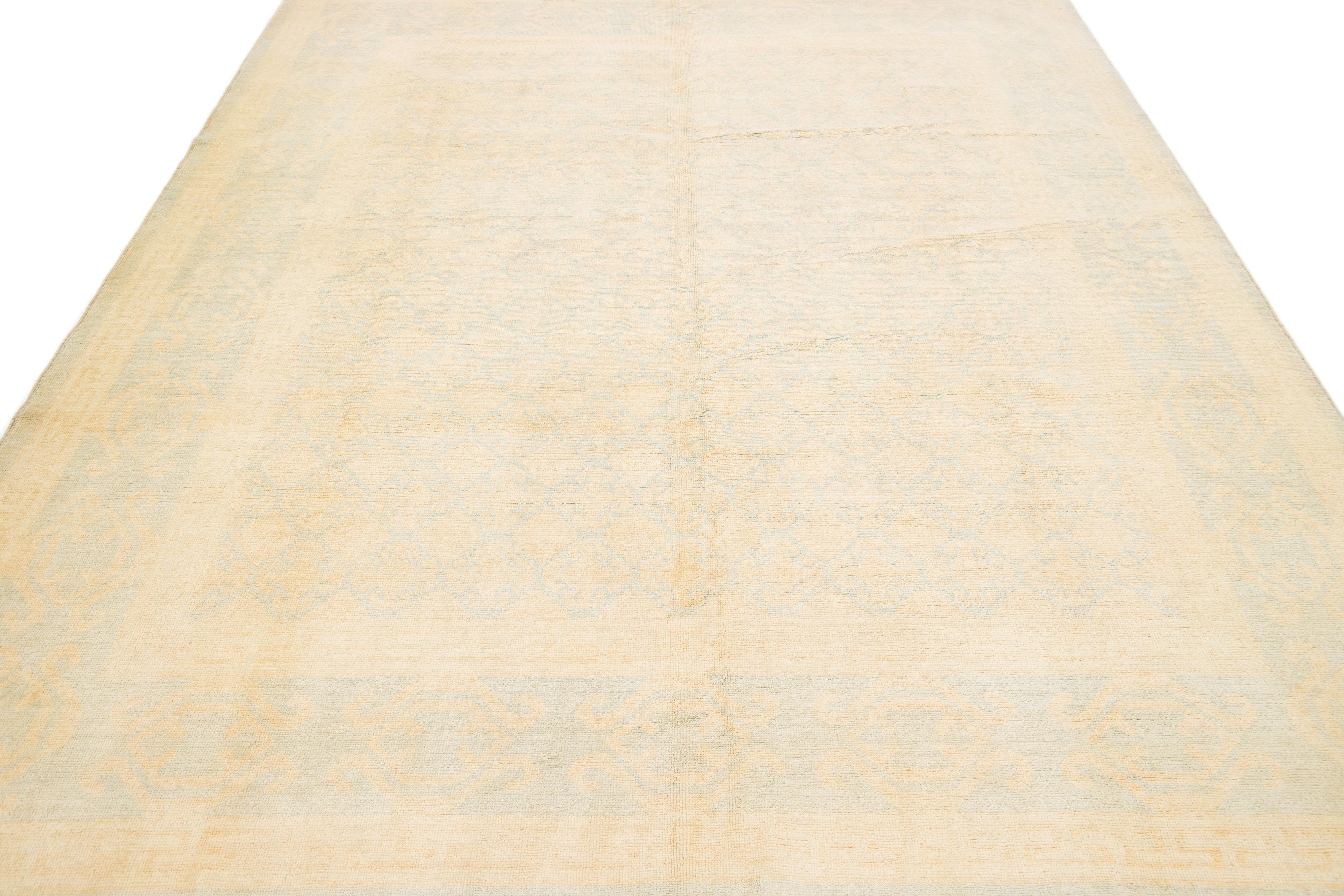 Beautiful modern Khotan tone-on-tone hand-knotted wool rug with a beige field. This piece has light blue accents all over a gorgeous design.

This rug measures: 8' x 9'6