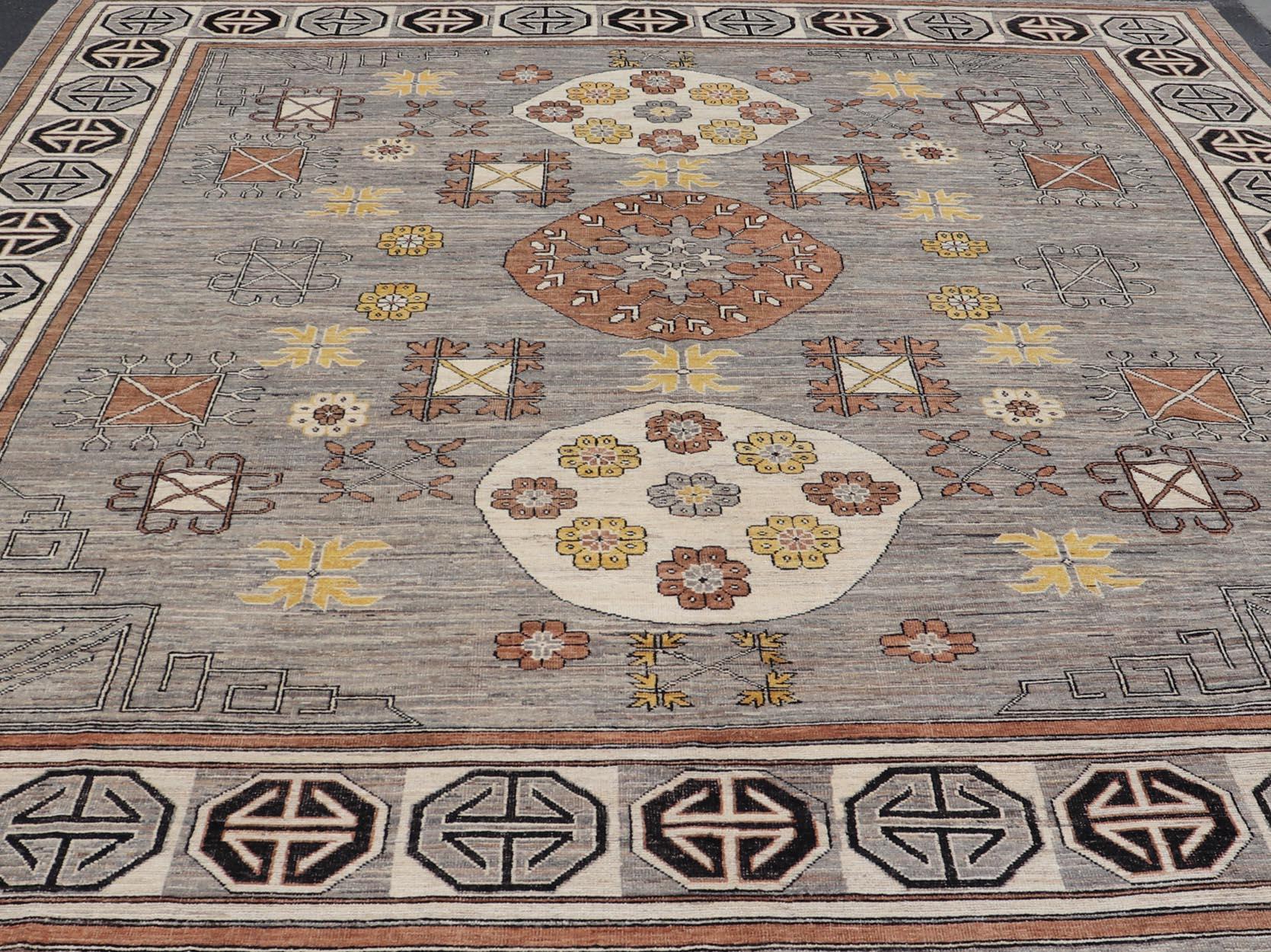 Modern Khotan Rug with Circular Medallions in Shades of Gray, Brown and Yellow. Keivan Woven Arts rug AFG-67299, Keivan Woven Arts / country of origin / type: Afghanistan / Khotan. 
Measures: 12'8 x 15'1 
This modern Khotan made rug features