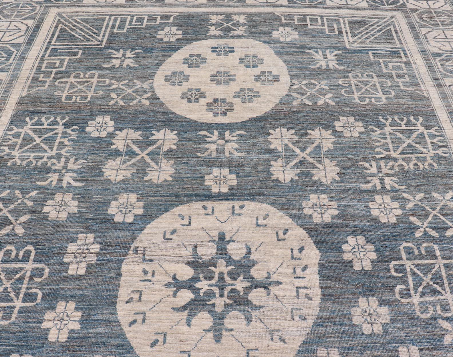 Modern Khotan long rug with circular medallions in shades of steel blue & off white. Keivan Woven Arts rug AFG-58337, Keivan Woven Arts / country of origin / type: Afghanistan / Khotan

Measures: 10'6 x 16'3 

This modern Khotan made rug
