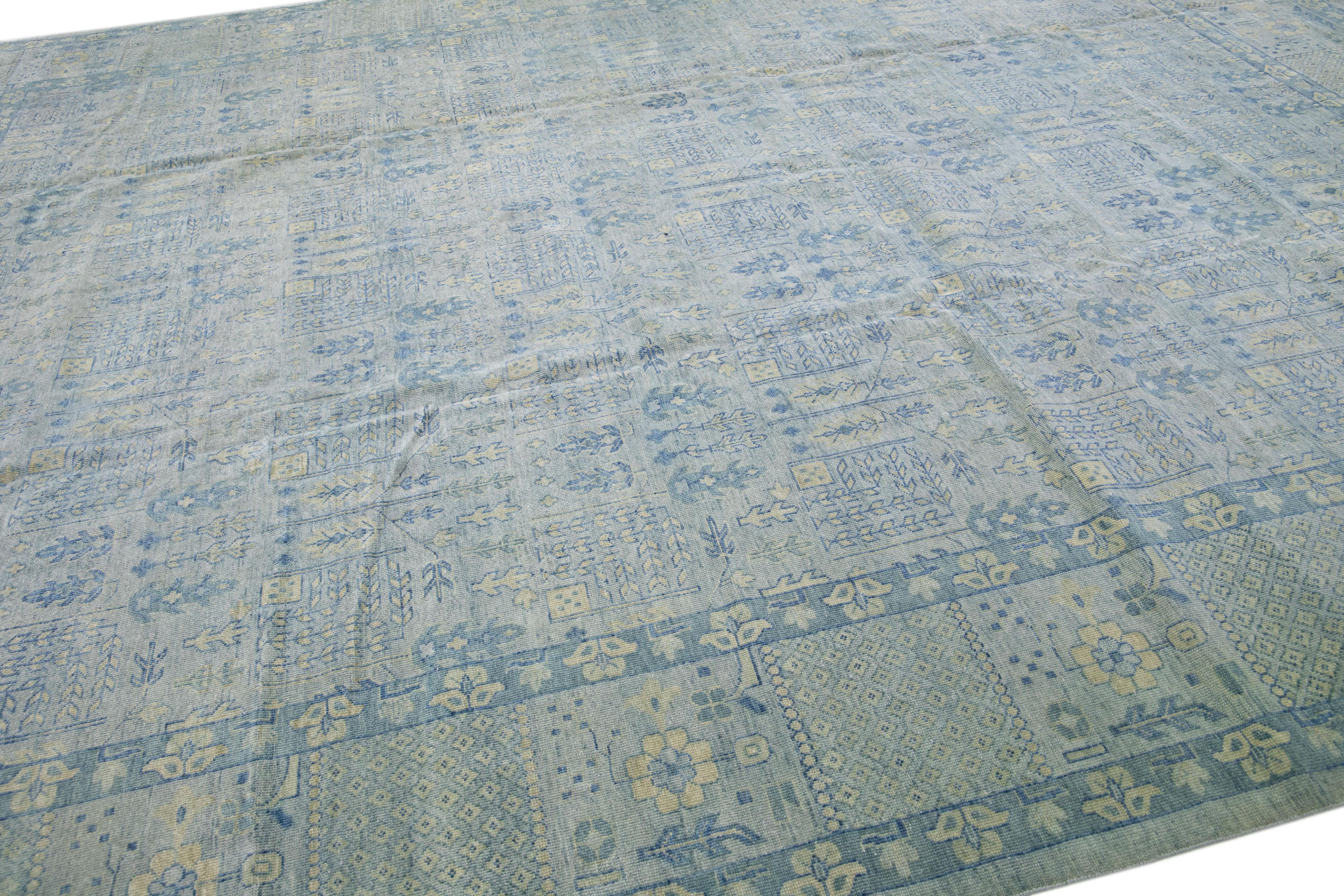 Beautiful modern Khotan-Style hand-knotted wool rug with a gray field. This piece has blue and beige accents in a gorgeous all-over floral pattern design.

This rug measures: 11'11