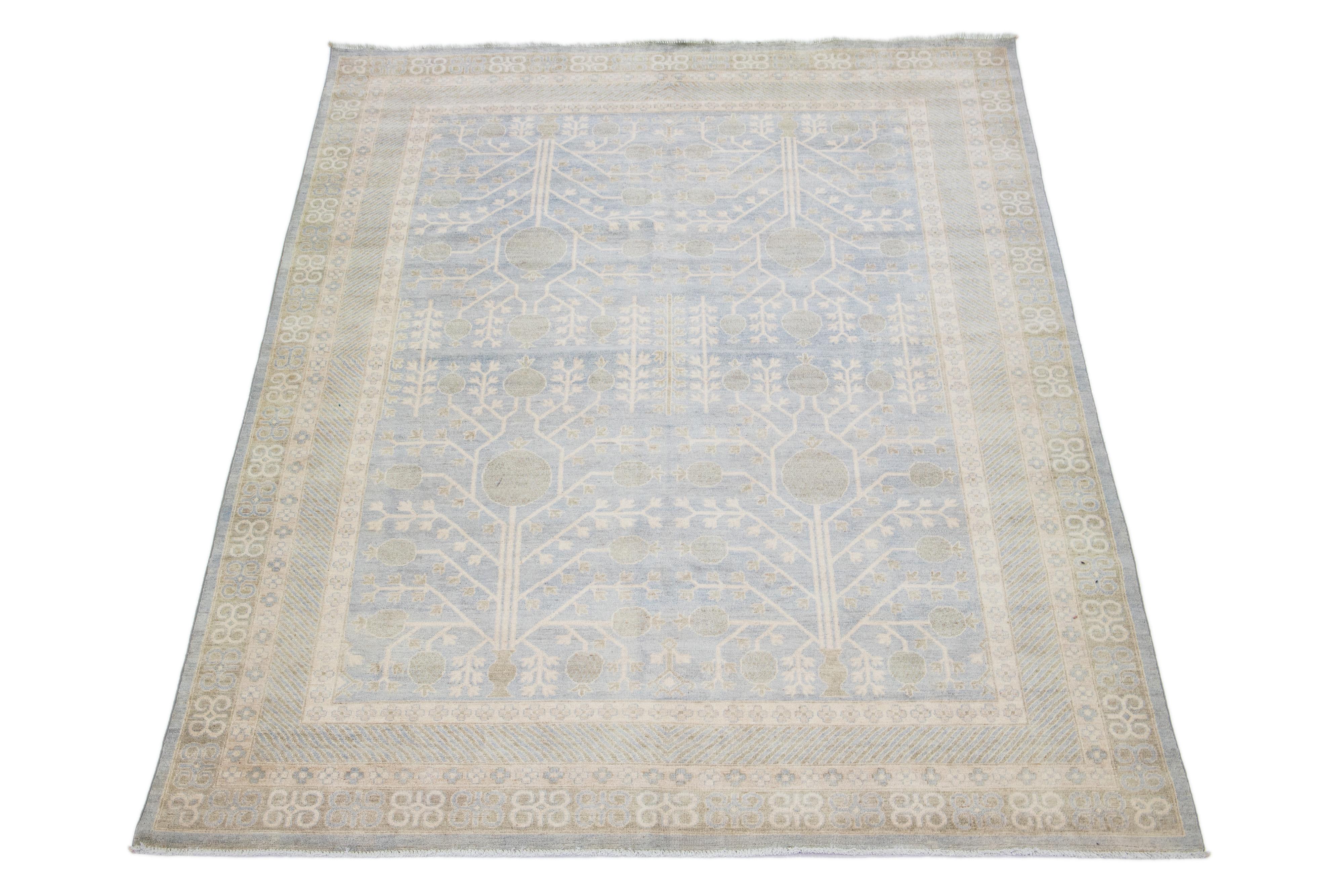 Beautiful modern Khotan-Style hand-knotted wool rug with a gray field. This piece has a designed frame with green and beige accents in a gorgeous all-over pattern design.

This rug measures: 8'9