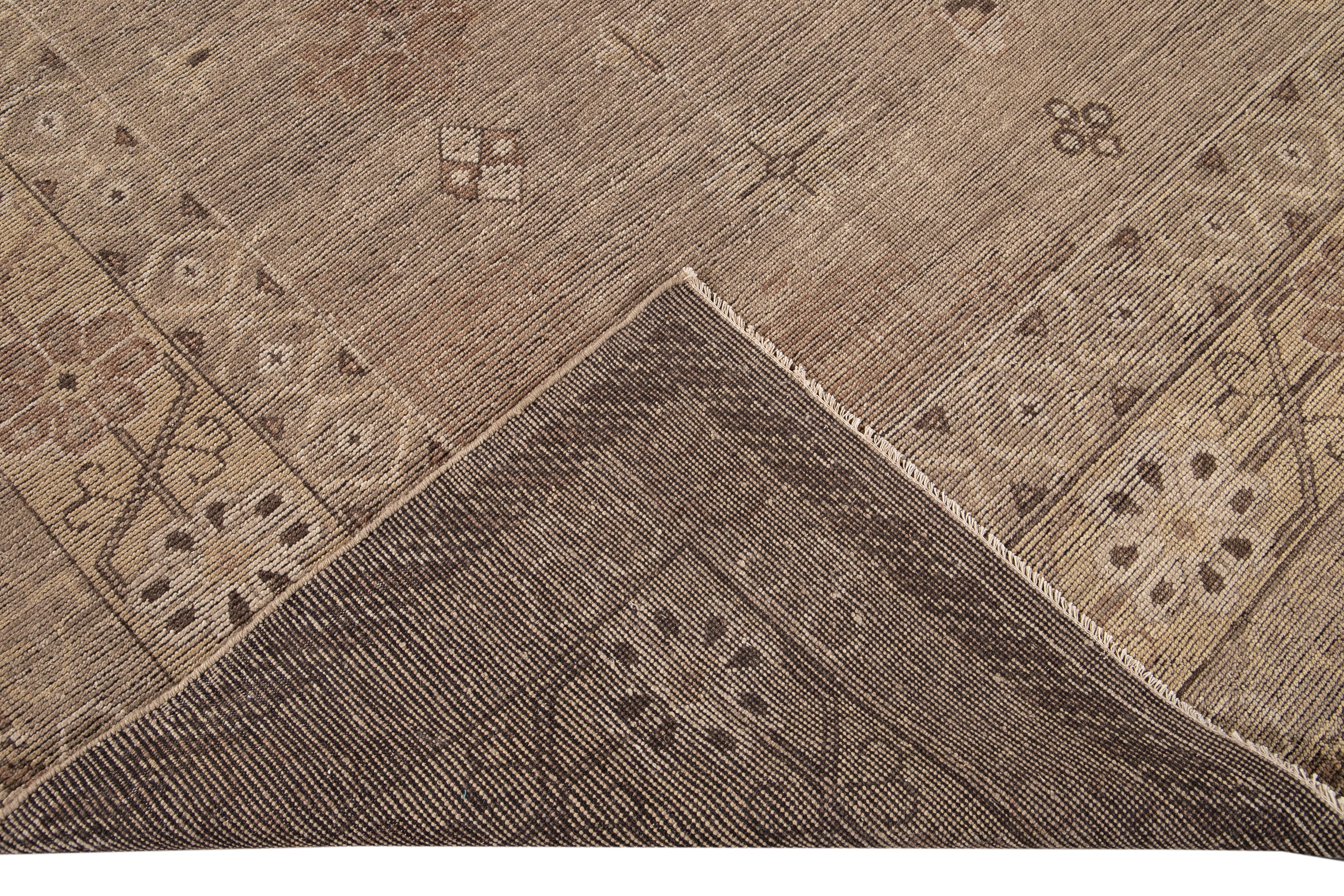 Beautiful modern oversize Khotan-style hand-knotted wool rug tan field. This Khotan-style rug has an accent of brown, beige, and Ivory in a gorgeous all-over geometric floral medallion design.

This rug measures: 11'10