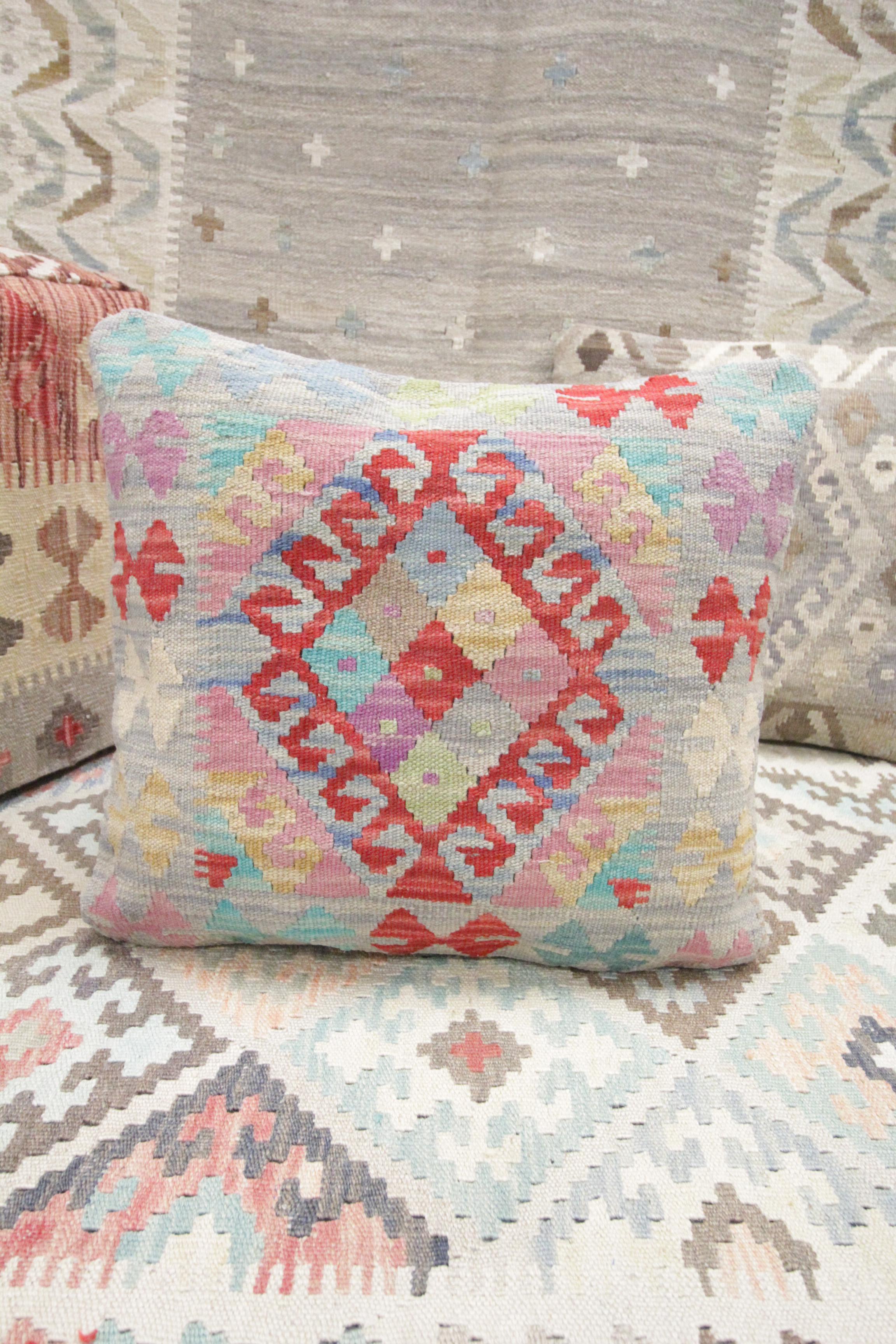 This new traditional Kilim cushion cover is a handwoven piece constructed in the early 21st century. The design has been delicately woven by hand and features a symmetrical geometric pattern that is sure to Stand out on any sofa or armchair! This