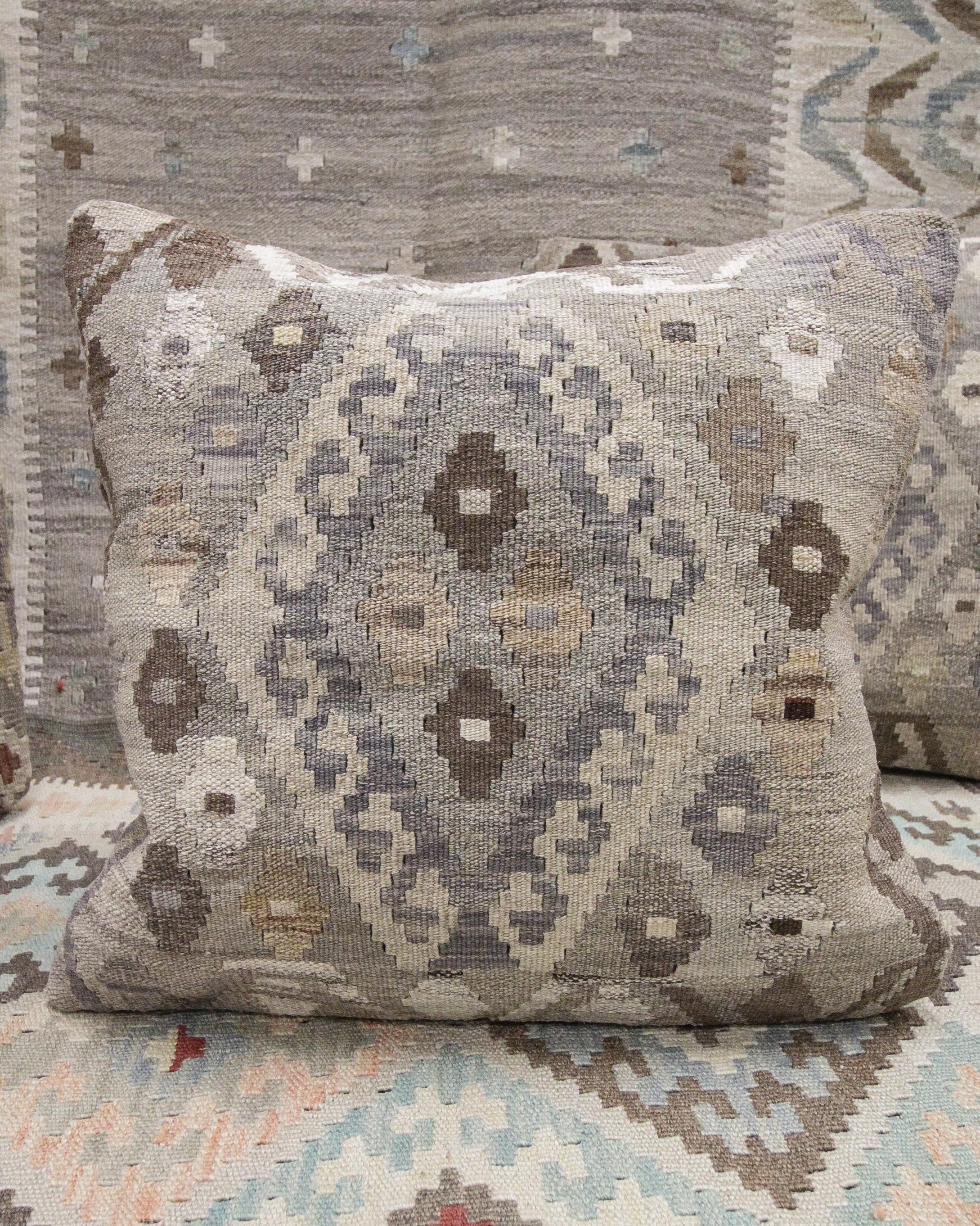 This new modern Scandinavian style kilim cushion cover is a handwoven piece constructed in the early 21st century. The design has been delicately woven by hand and features a symmetrical geometric pattern that is sure to stand out on any sofa or