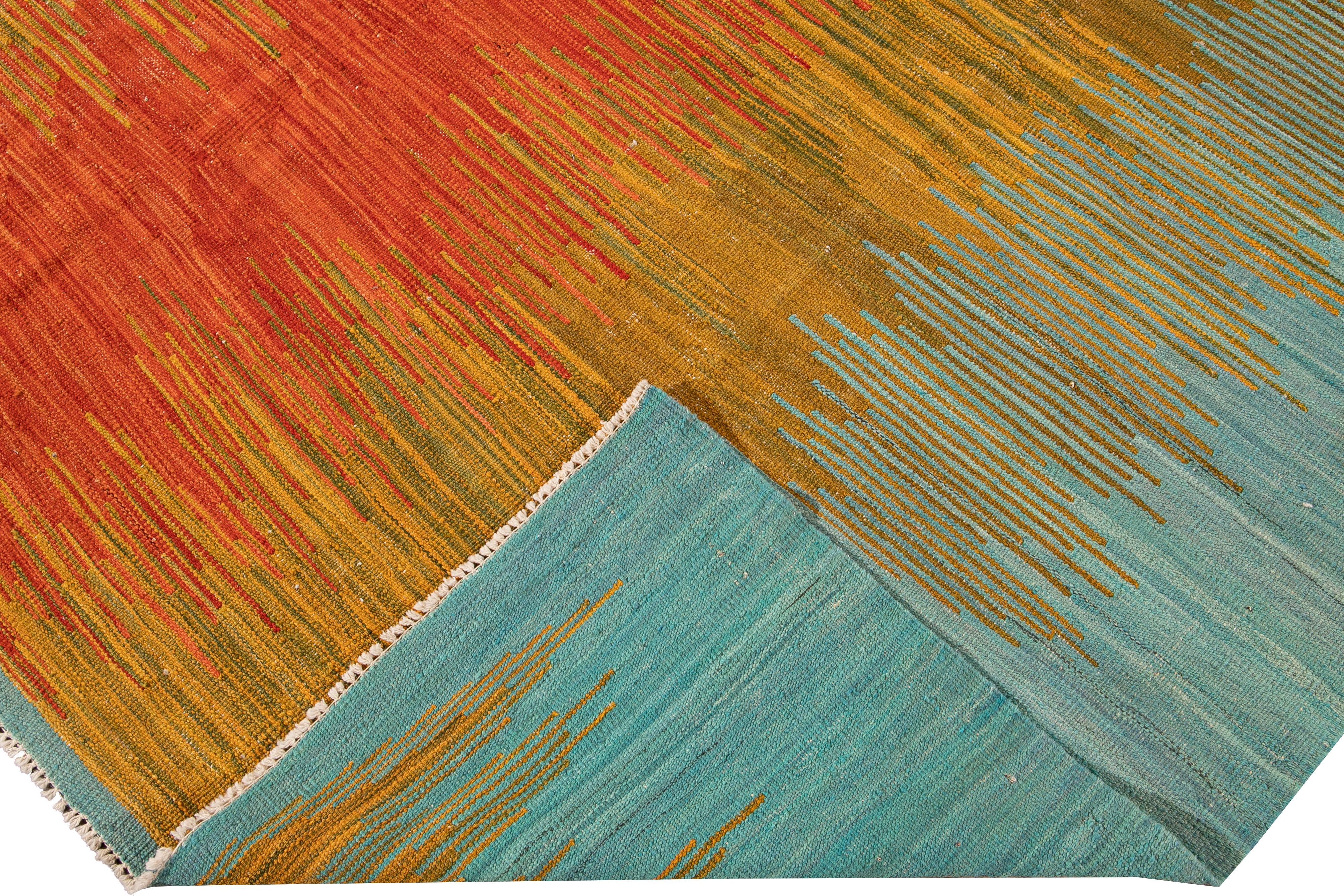 Beautiful modern Kilim flat-weave wool rug. This Kilim rug full of art has an orange, yellow, and blue field in a gorgeous geometric color abstract design.

This rug measures: 7'9