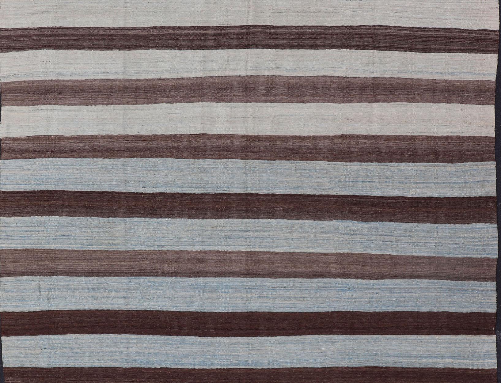 Flat-weave Kilim rug with stripes with modern design in shades of blue's, brown's Keivan Woven Arts / rug AFG-155, country of origin / type: Afghanistan / Kilim

This beautiful Kilim piece features a Classic stripe design that evokes casual and