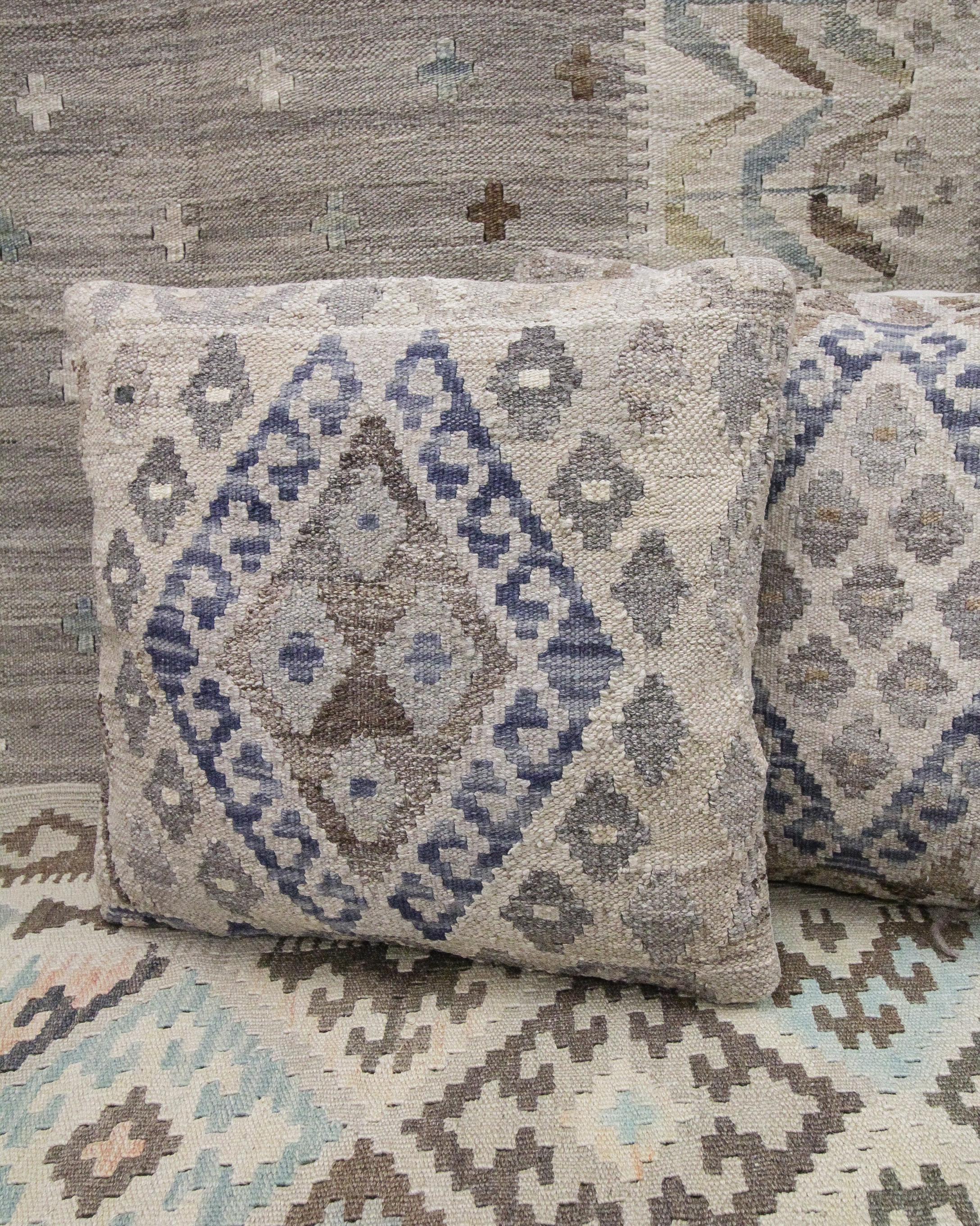 This new traditional kilim cushion cover is a handwoven piece constructed in the early 21st century. The design has been delicately woven by hand and features a symmetrical geometric pattern that is sure to stand out on any sofa or armchair! This