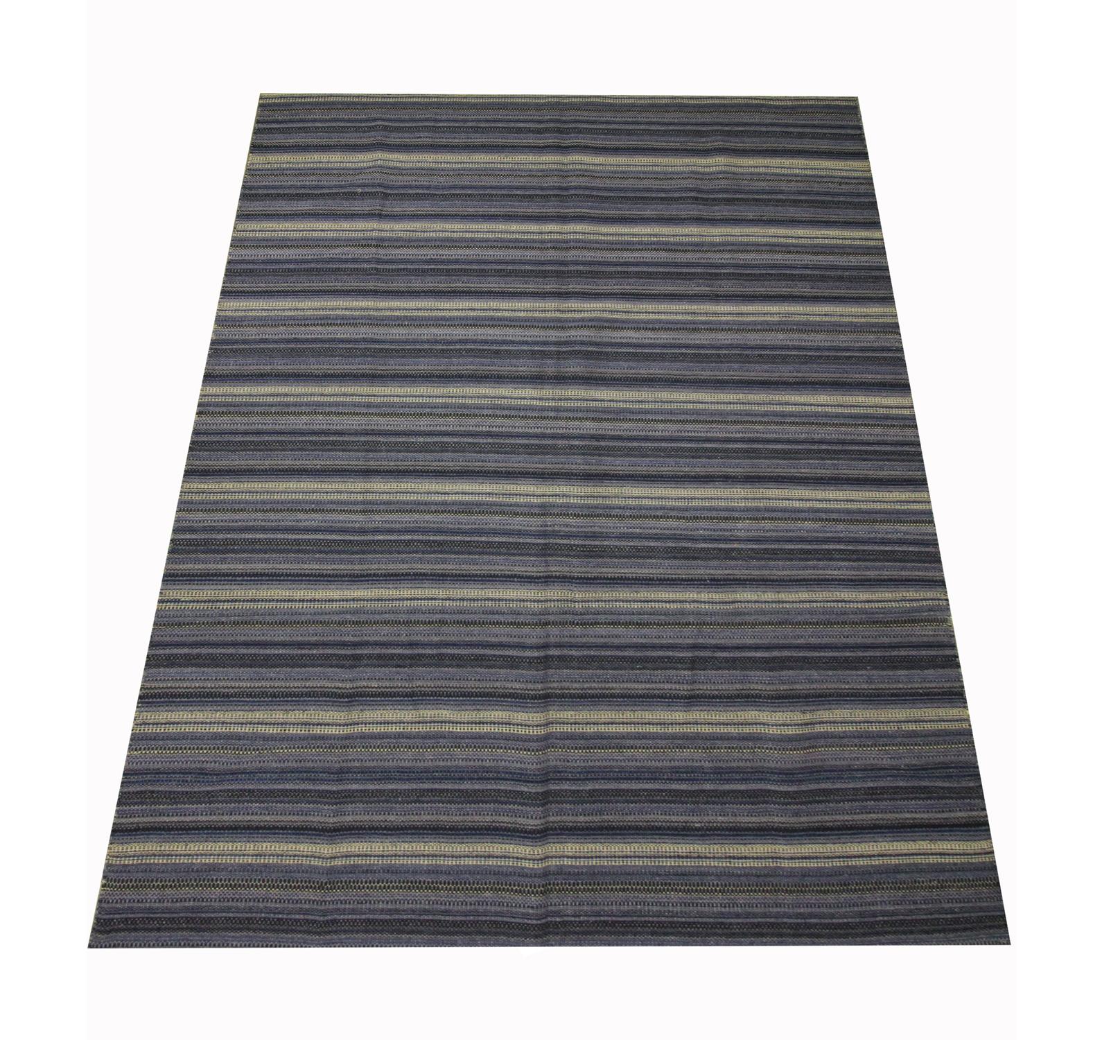 This bold striped carpet area rug is a flat woven kilim, woven by hand in the early 21st century. The design features an abstract colourful pattern woven in accents of yellow, grey and black. The colour and the design make this piece the perfect
