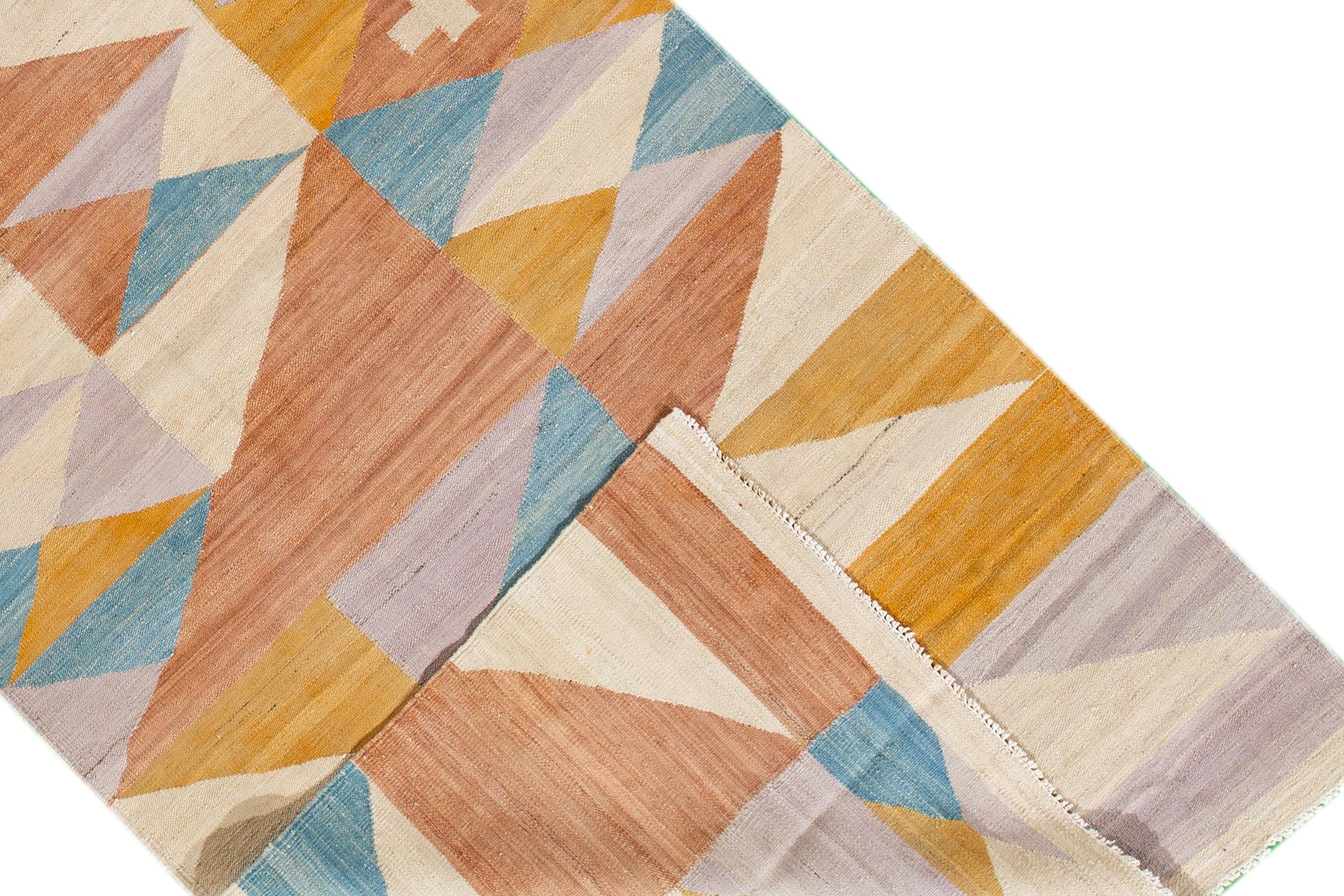 A hand-knotted modern Kilim rug with a geometric design. This rug measures 3'5